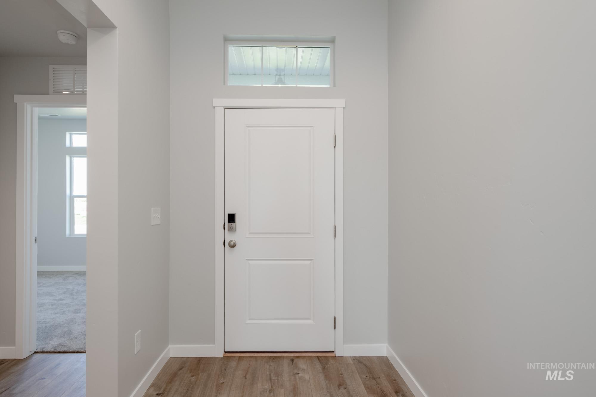 Foyer entrance with plenty of natural light and light wood-type flooring