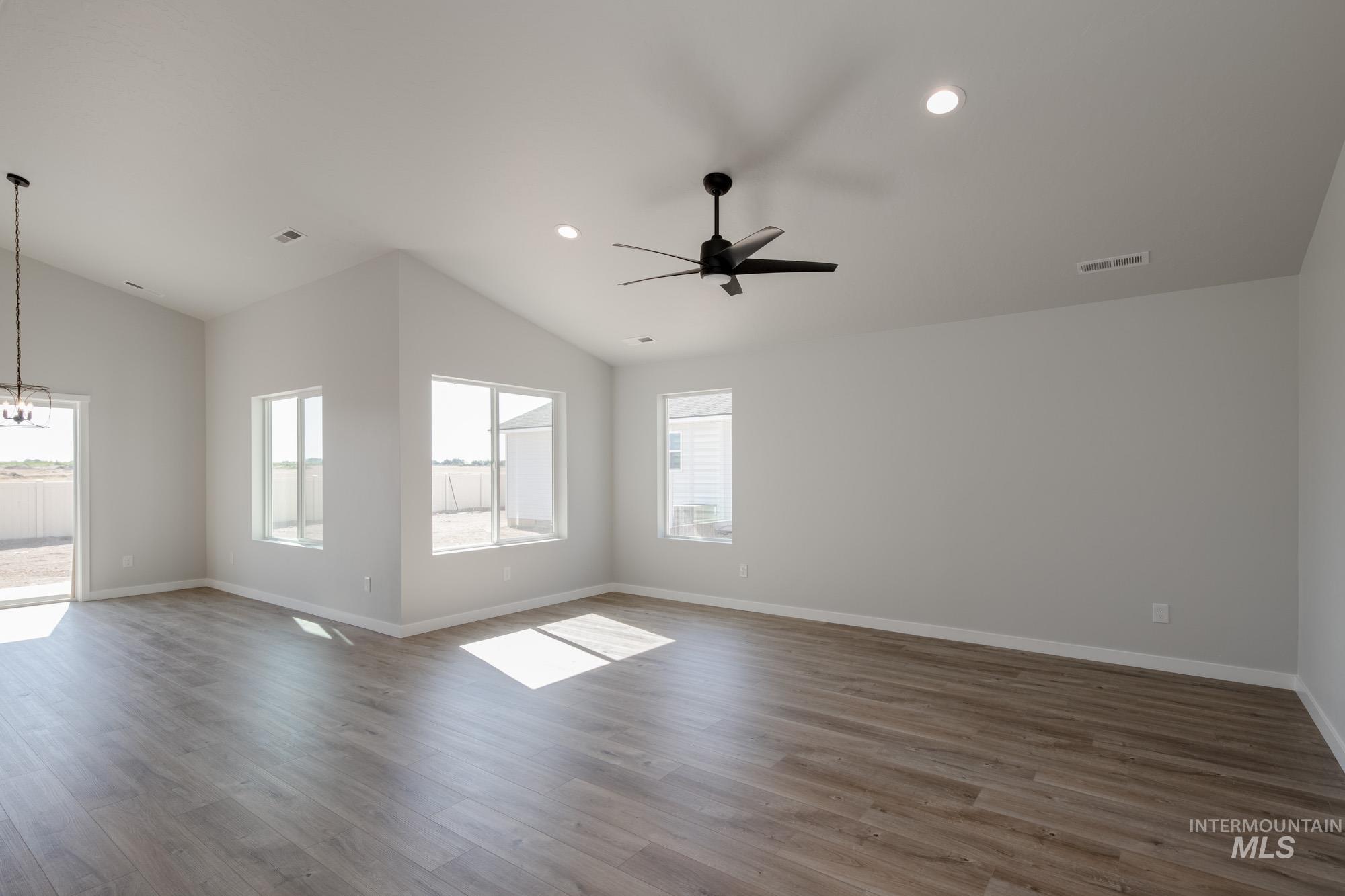 Unfurnished room featuring light wood-type flooring, lofted ceiling, recessed lighting, and ceiling fan