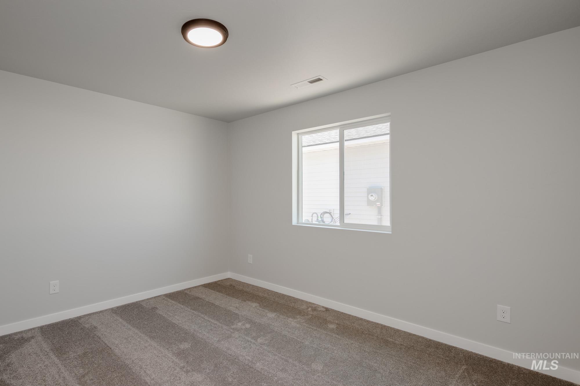 Unfurnished room featuring carpet flooring and baseboards