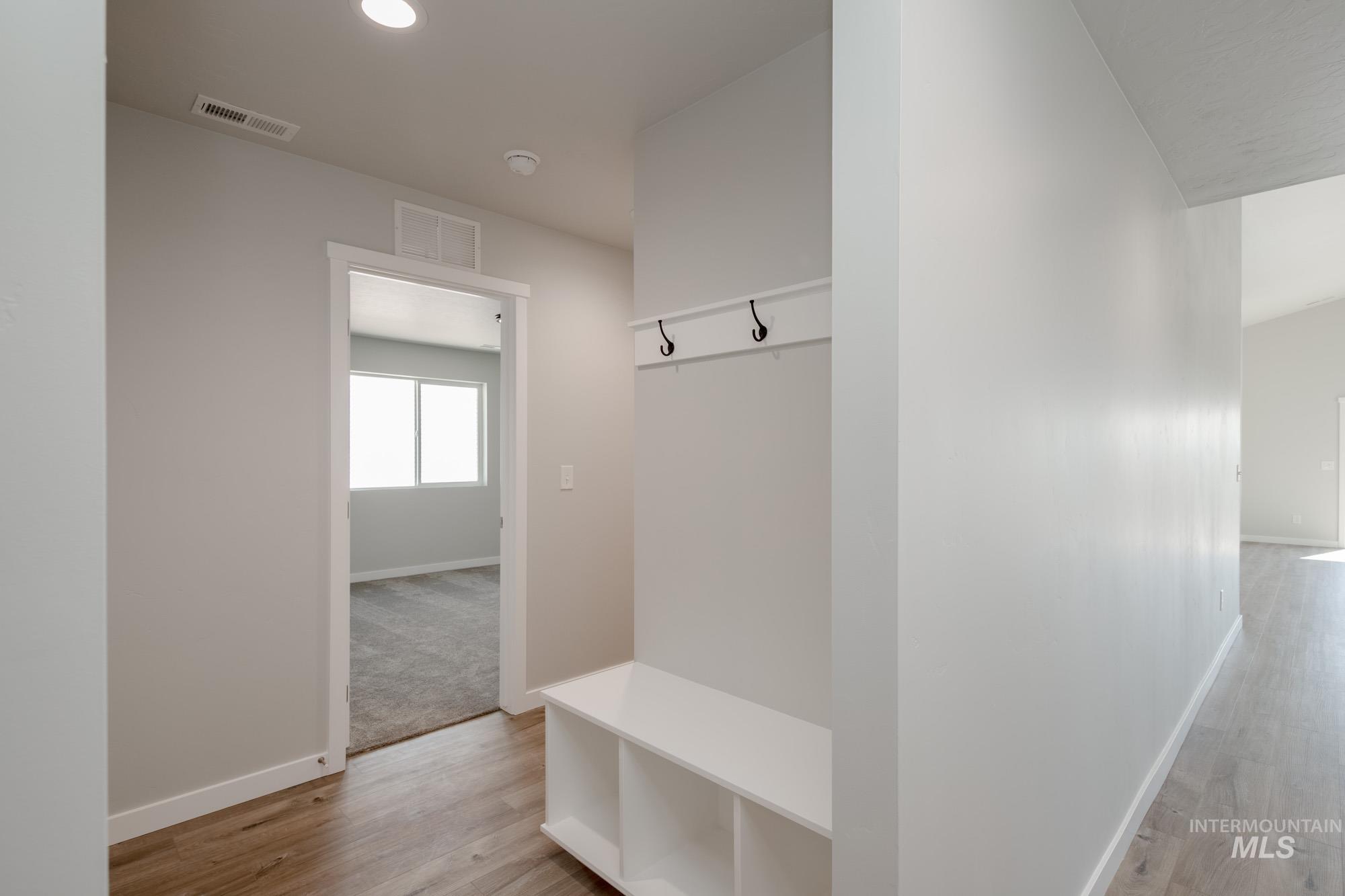 Mudroom with light wood-style flooring and recessed lighting