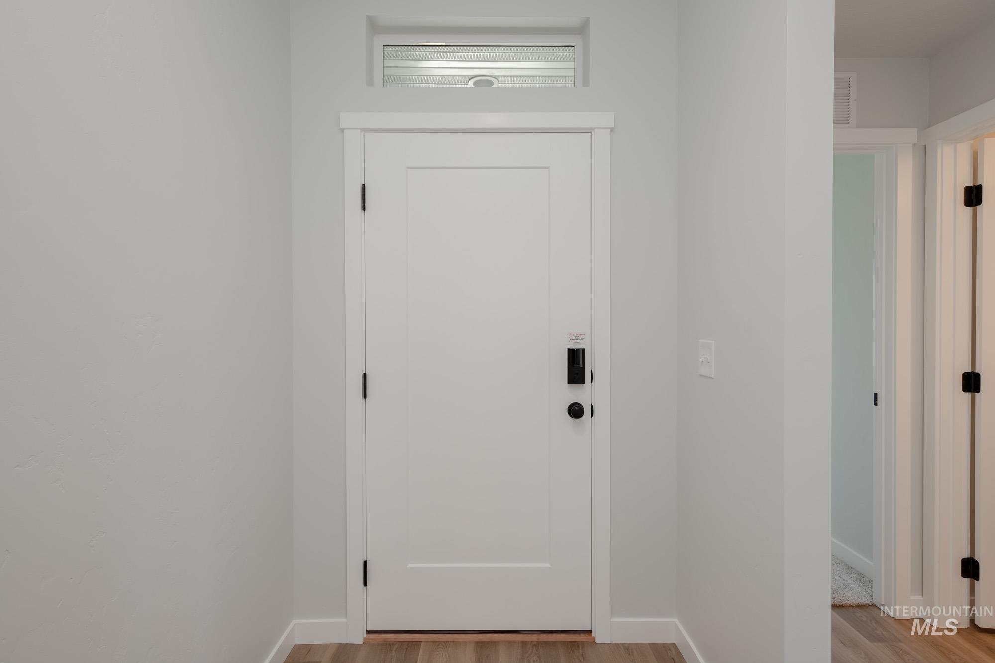 Doorway to outside featuring wood finished floors