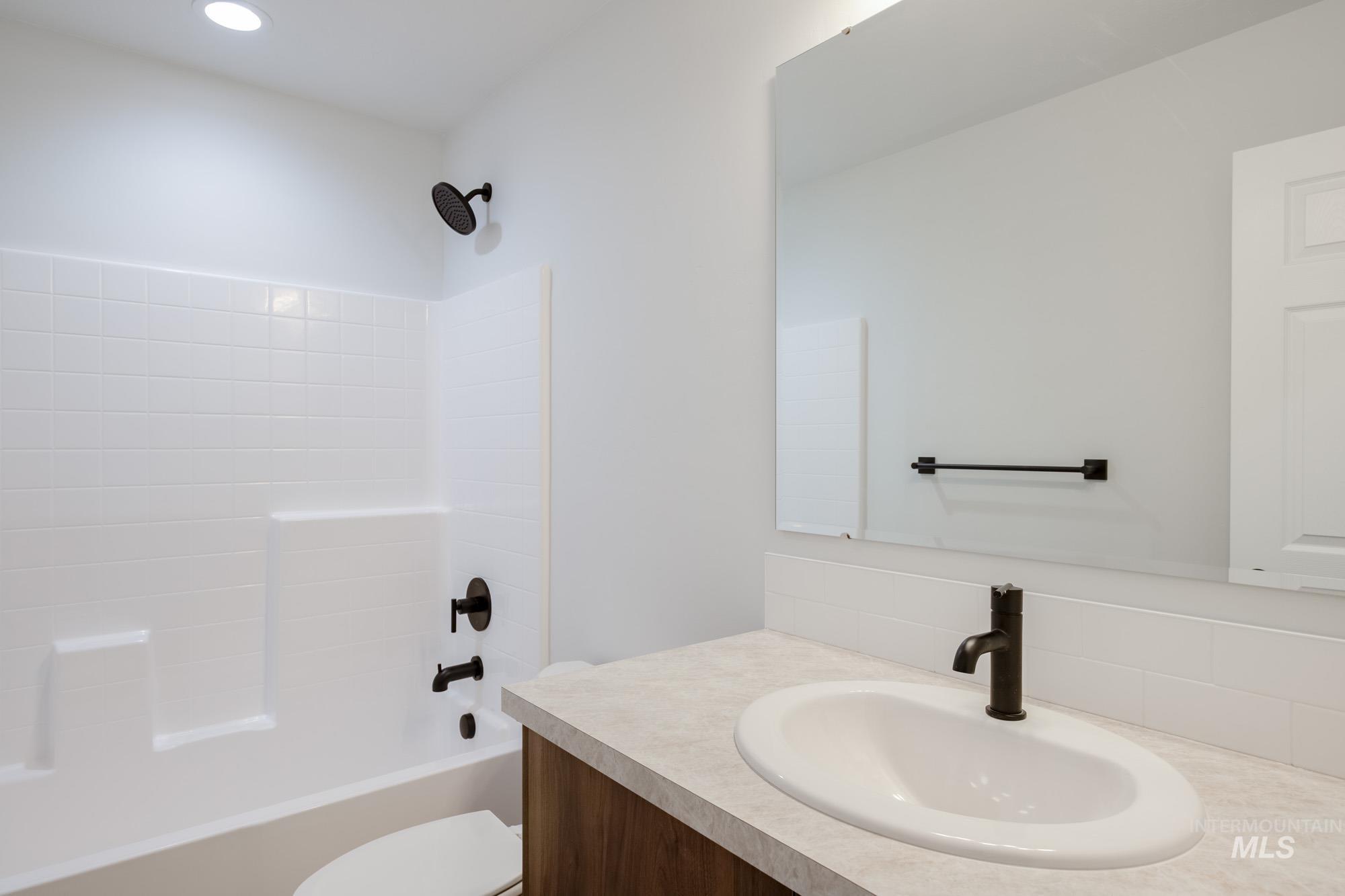 Bathroom featuring vanity and shower / tub combination