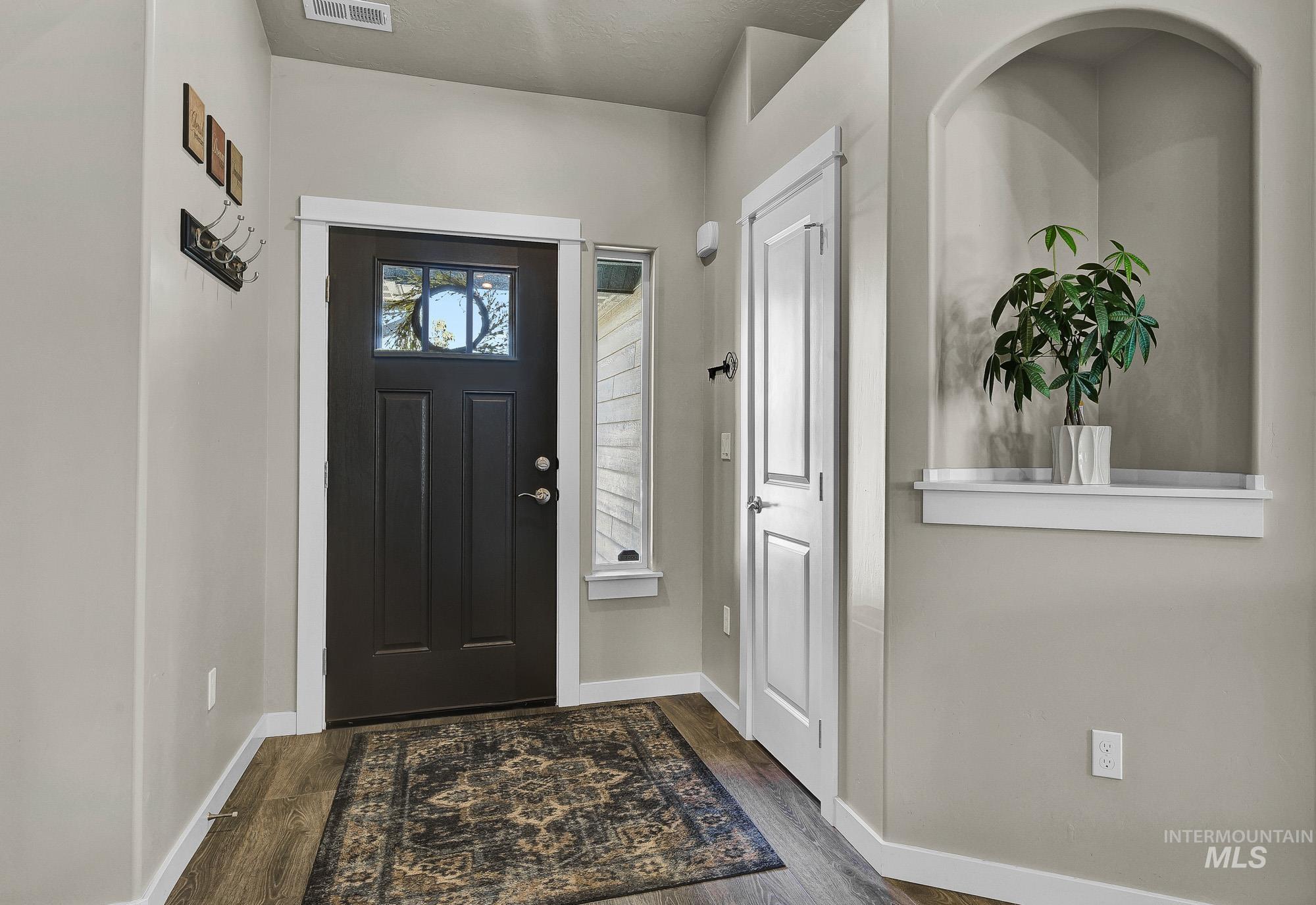 Foyer with dark wood-style flooring