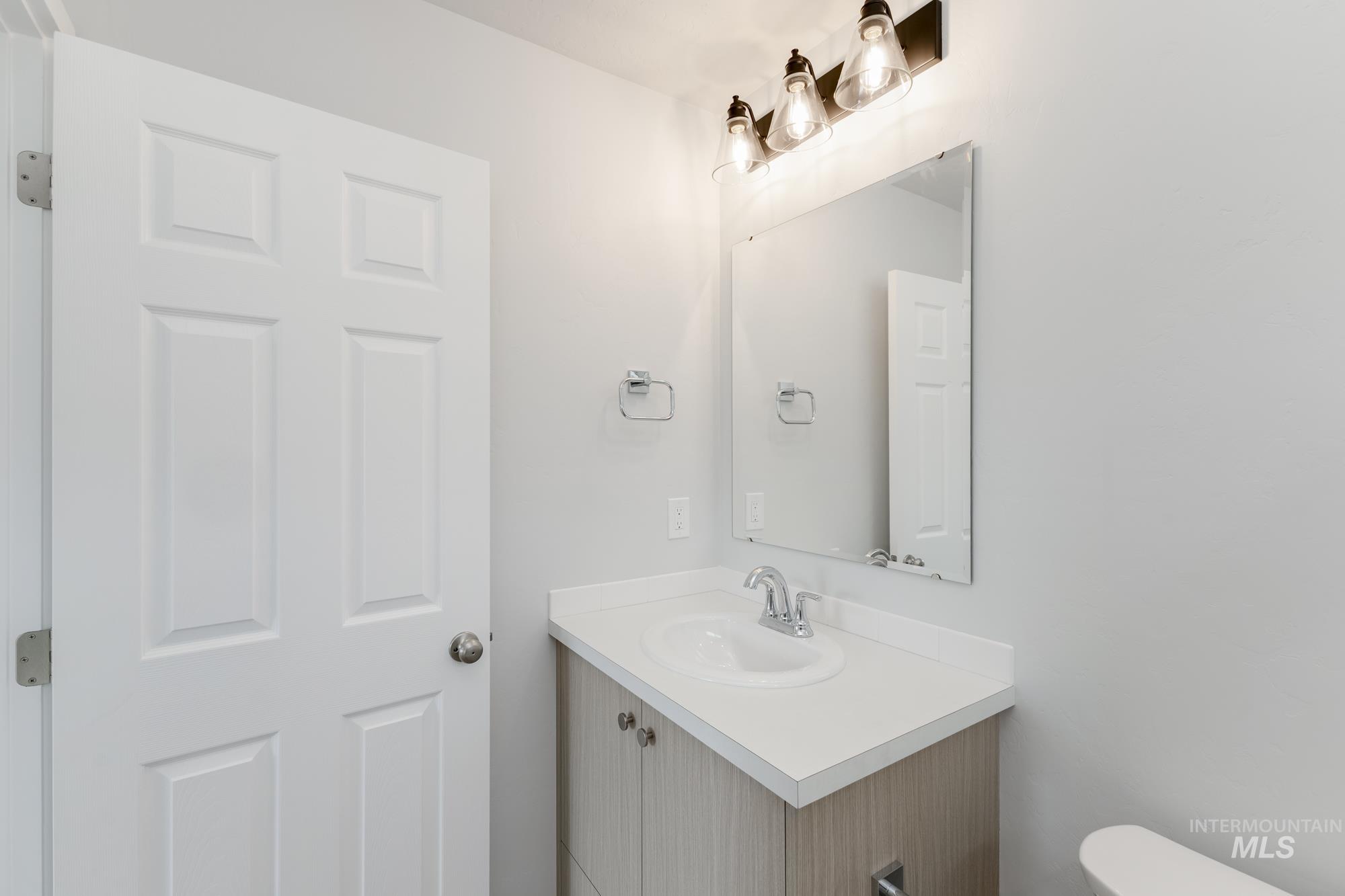 Half bath with vanity and toilet
