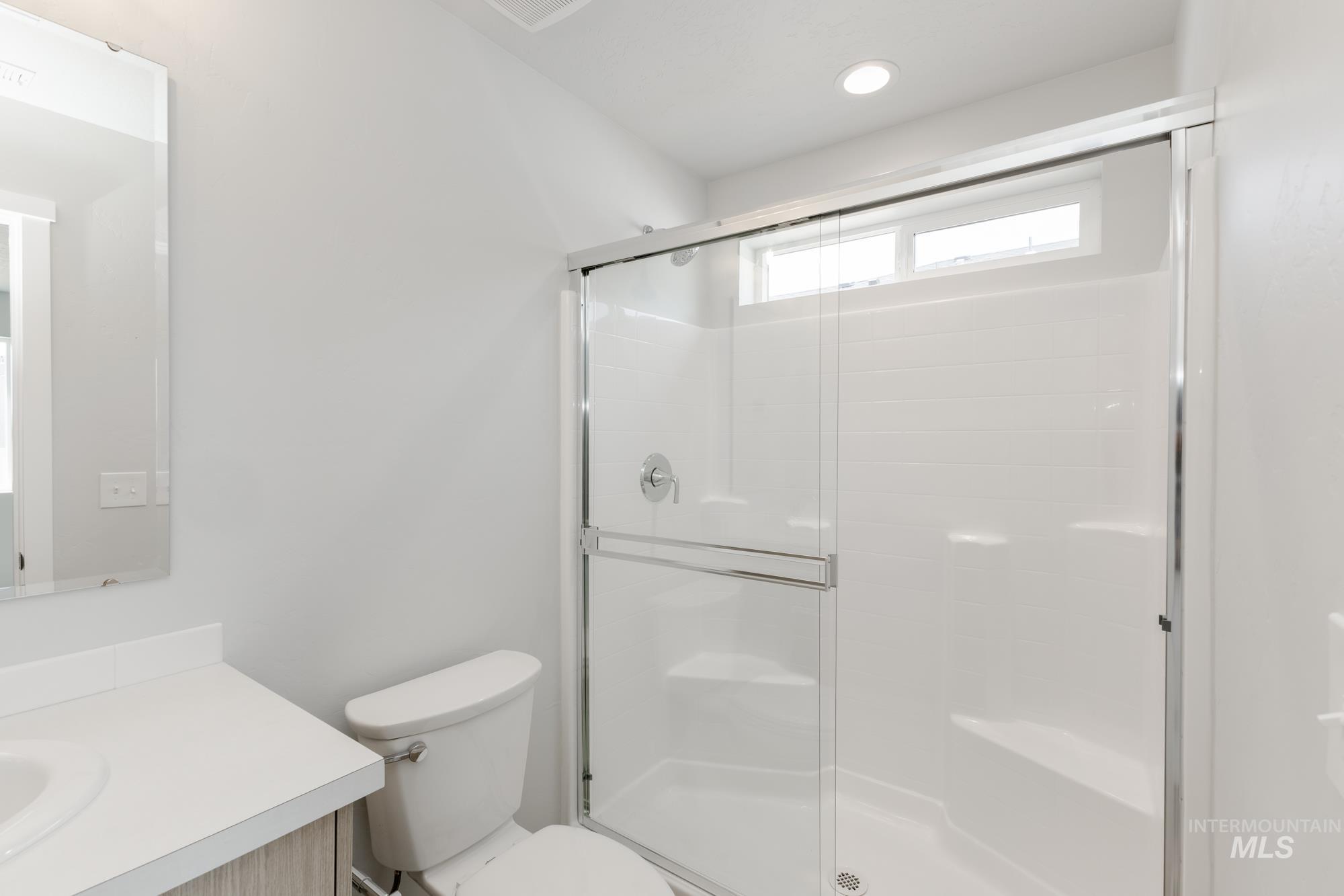 Bathroom with vanity and a shower stall