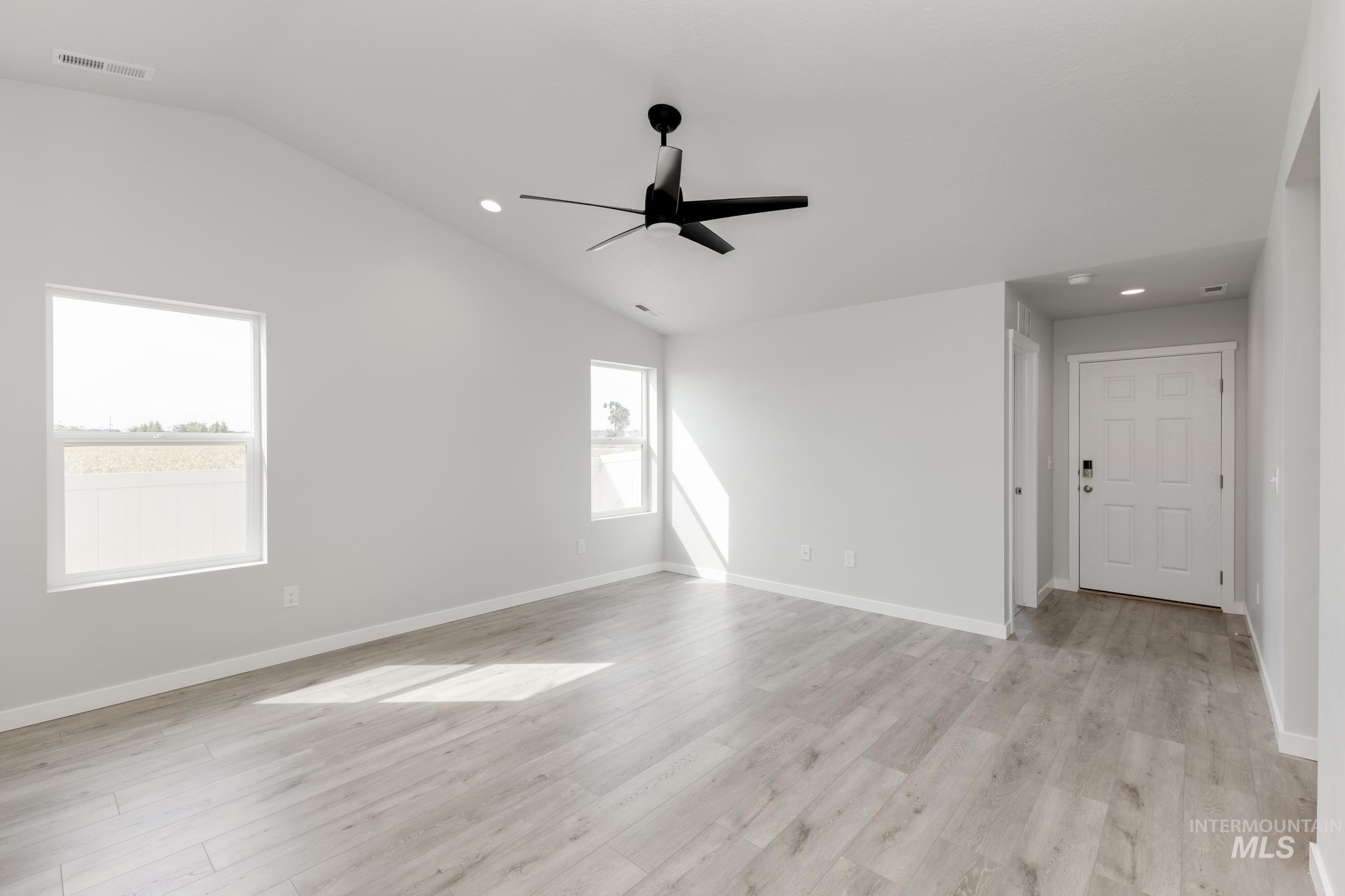 Unfurnished room featuring lofted ceiling, recessed lighting, light wood finished floors, and a ceiling fan