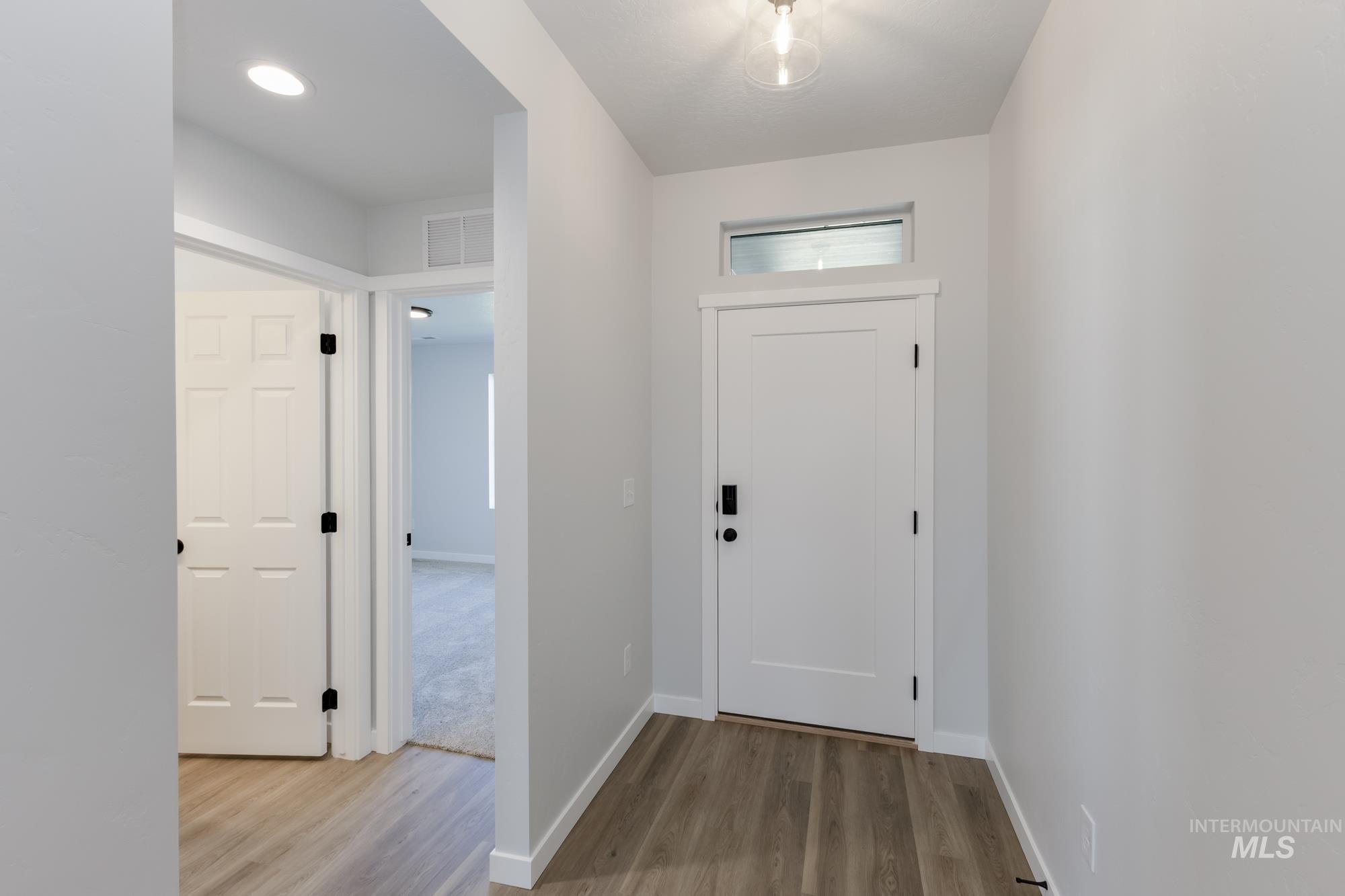 Foyer featuring light wood finished floors and recessed lighting