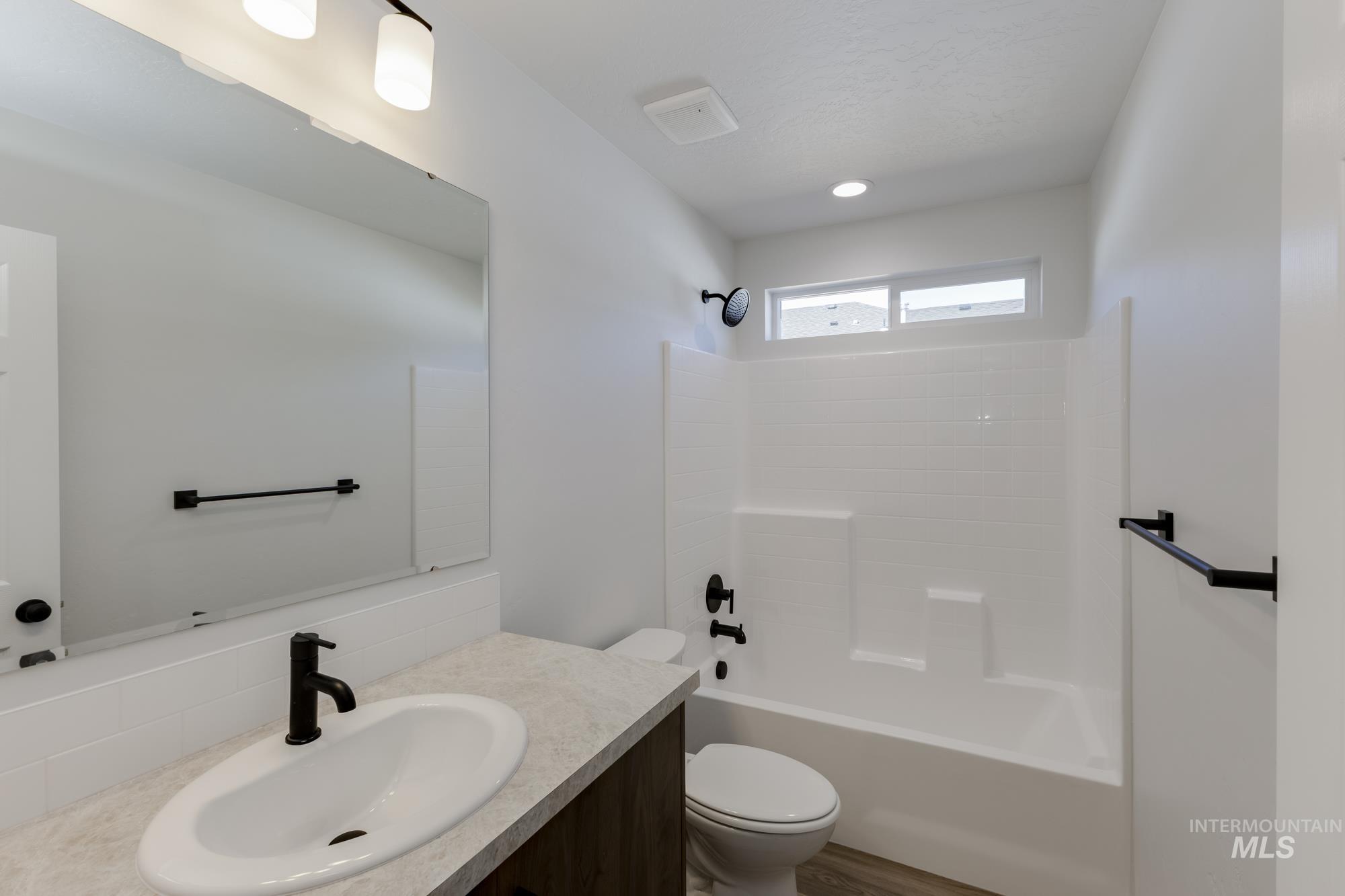 Full bathroom featuring vanity and tub / shower combination