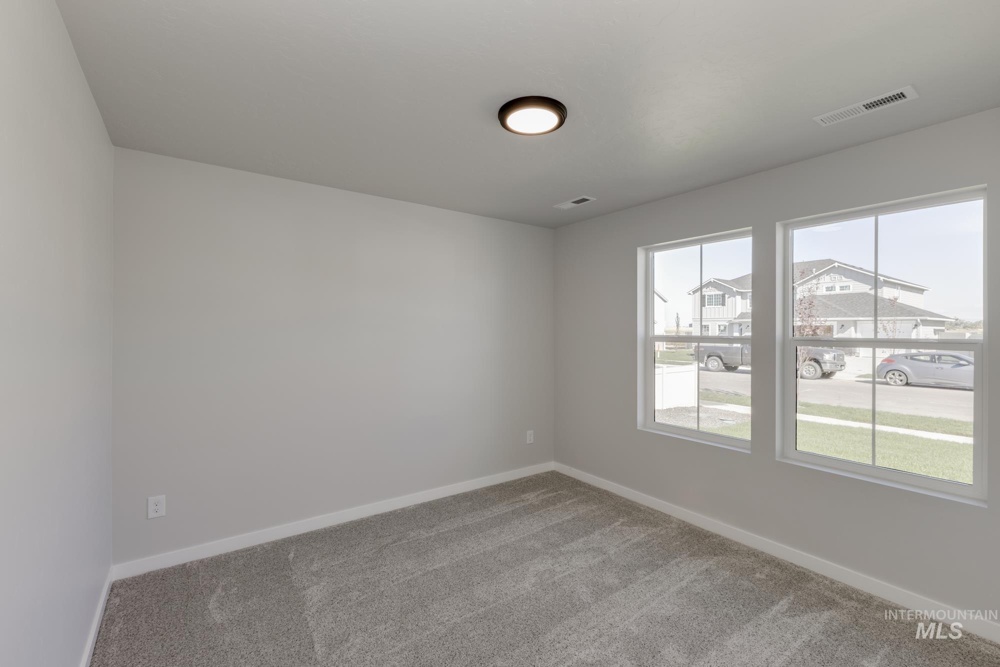 Unfurnished room featuring carpet and baseboards