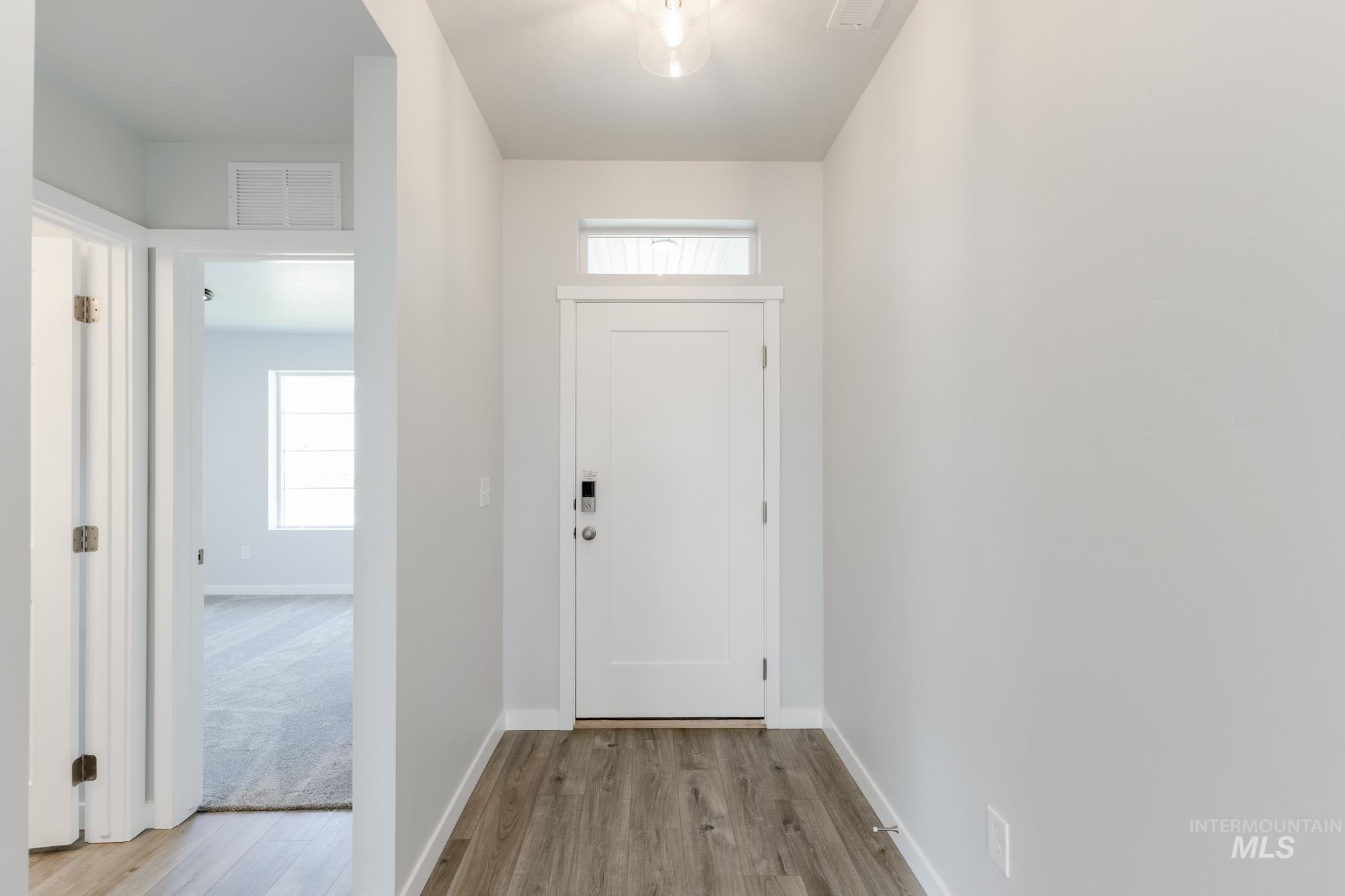 Entryway with baseboards and light wood-style flooring