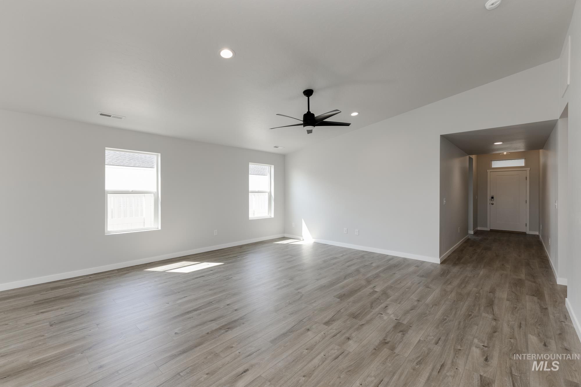 Empty room featuring light wood-style floors, recessed lighting, and ceiling fan