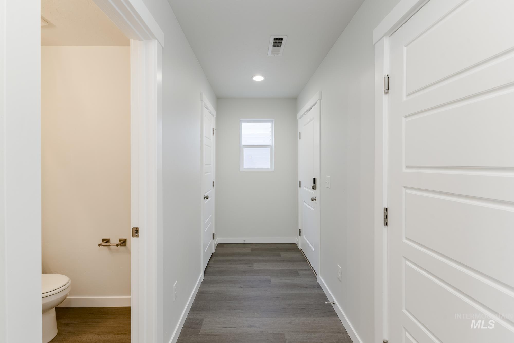 Hallway featuring dark wood-style floors and recessed lighting