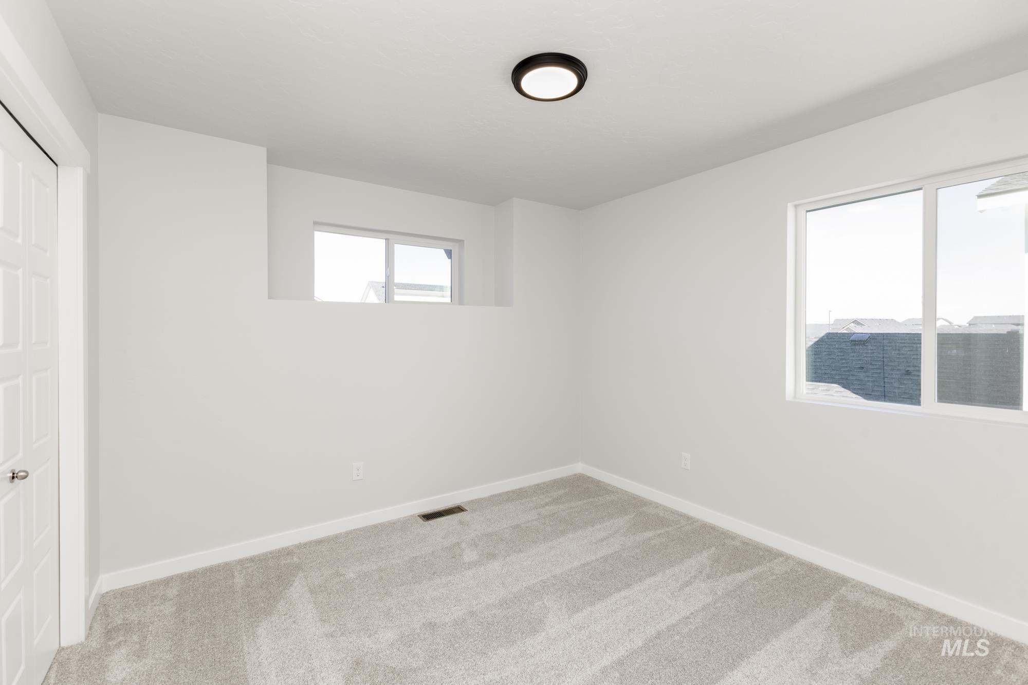 Unfurnished bedroom with carpet and baseboards