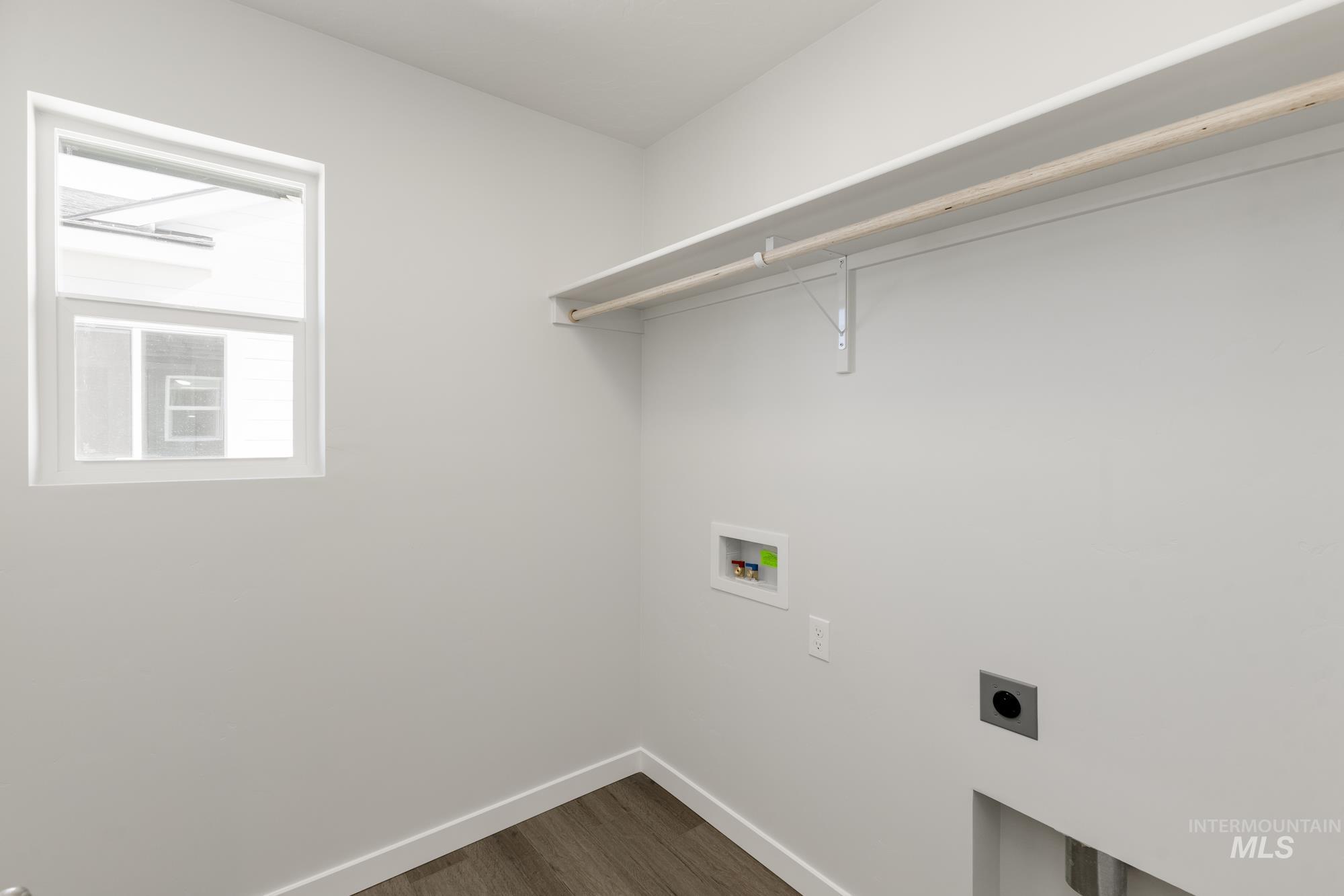 Laundry room with dark wood-style floors, electric dryer hookup, and hookup for a washing machine