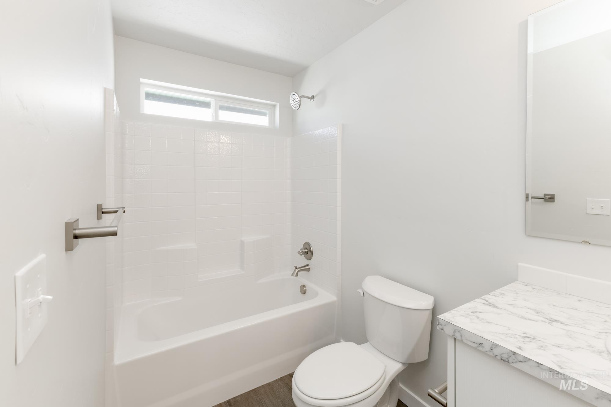 Bathroom featuring tub / shower combination and vanity
