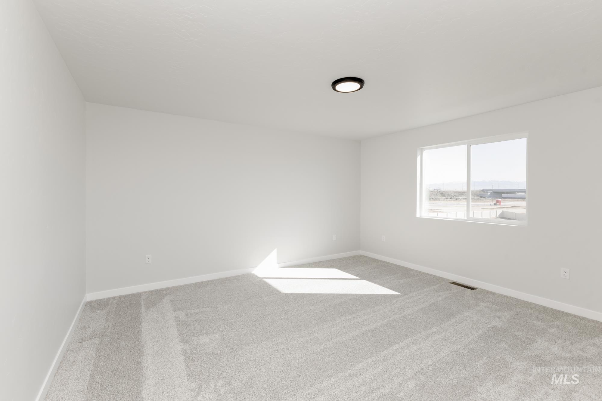 Unfurnished room featuring carpet and baseboards