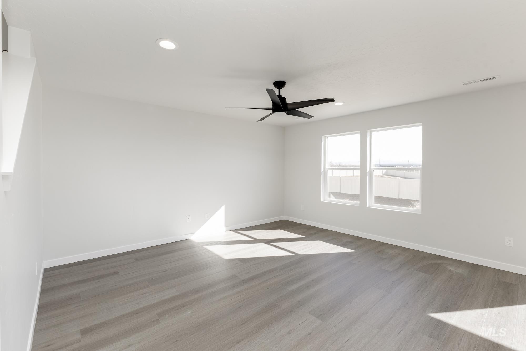 Unfurnished room featuring wood finished floors, recessed lighting, and a ceiling fan