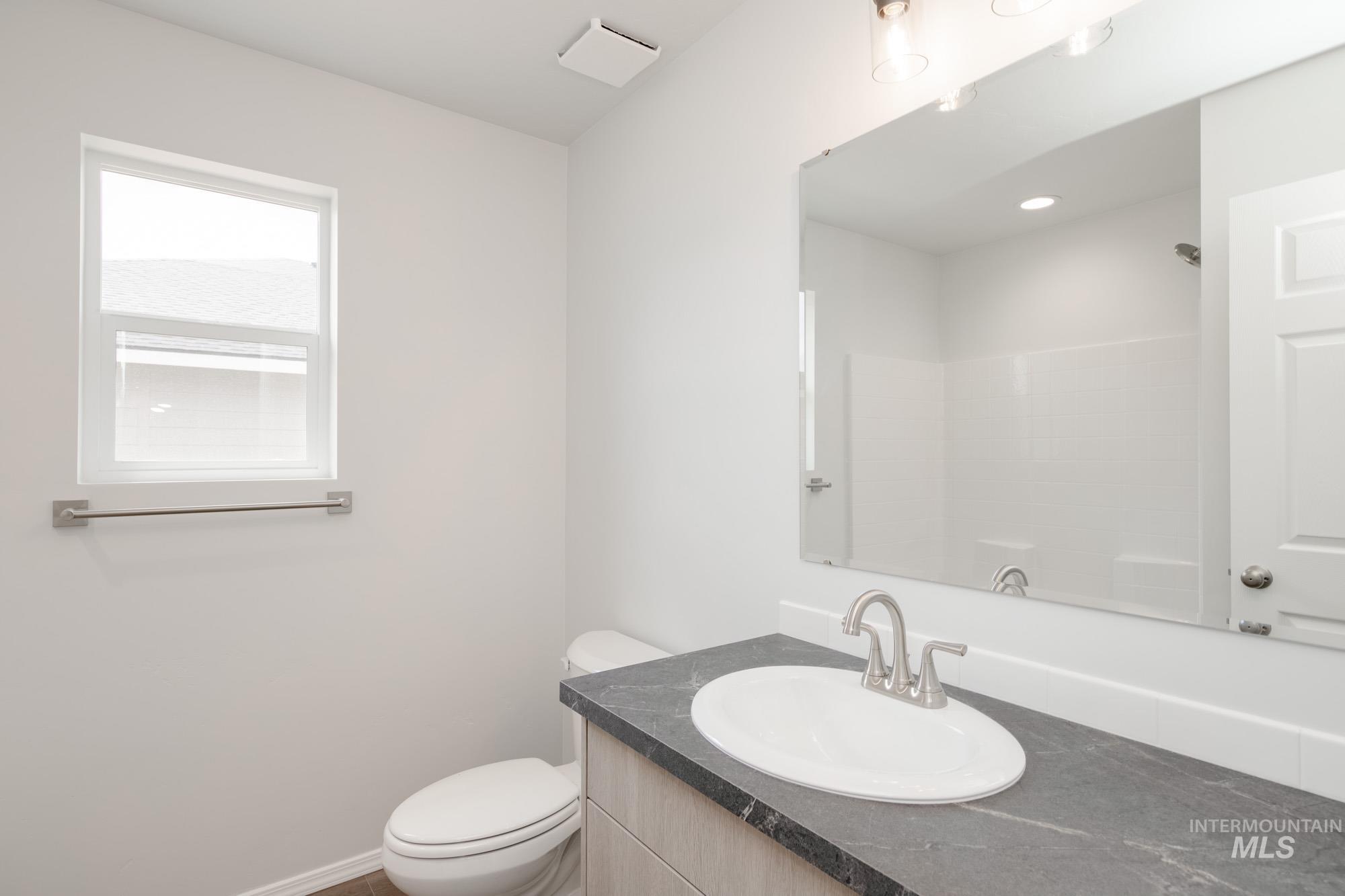 Full bathroom featuring vanity and toilet