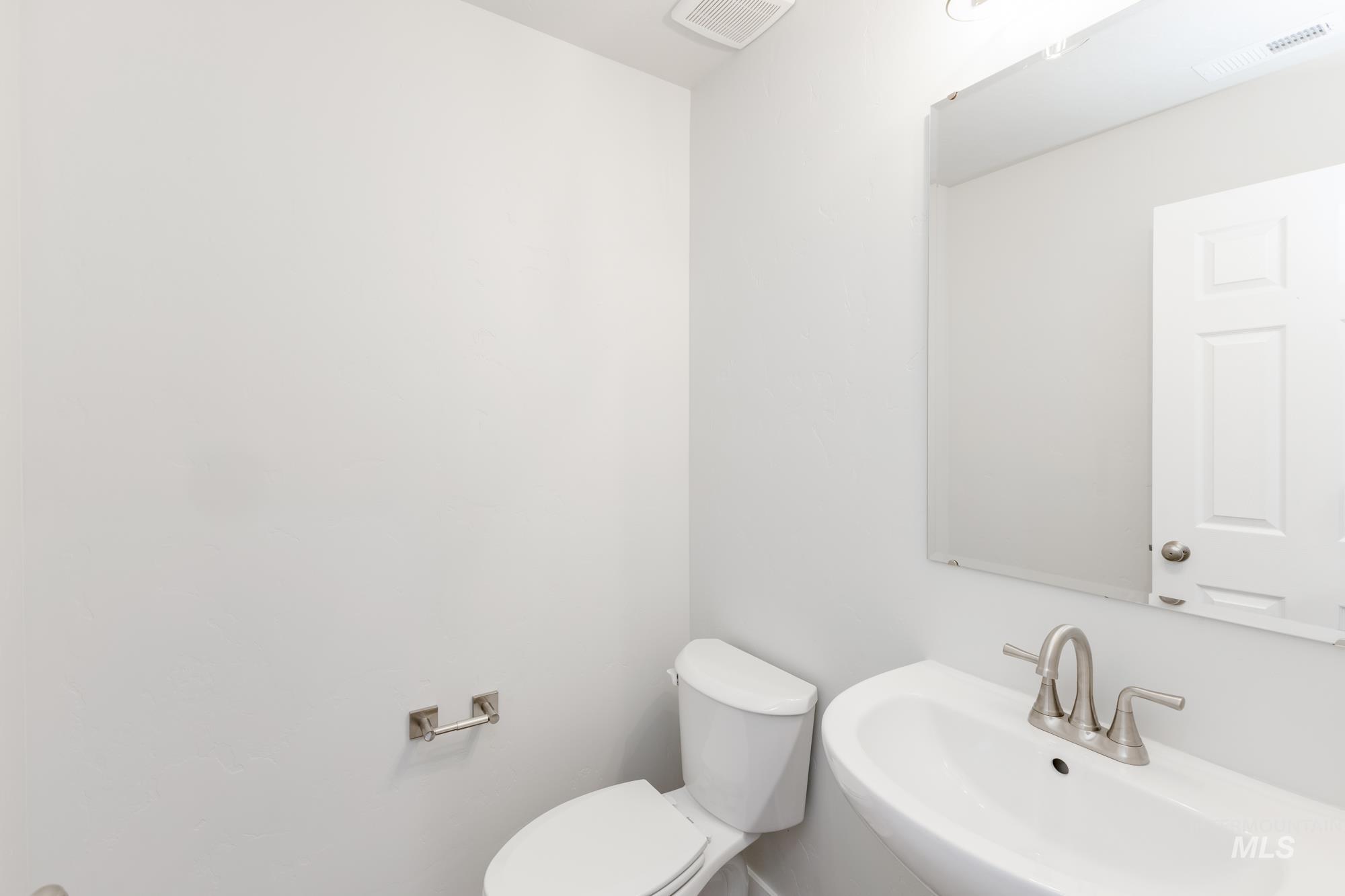 Half bath with toilet and a sink