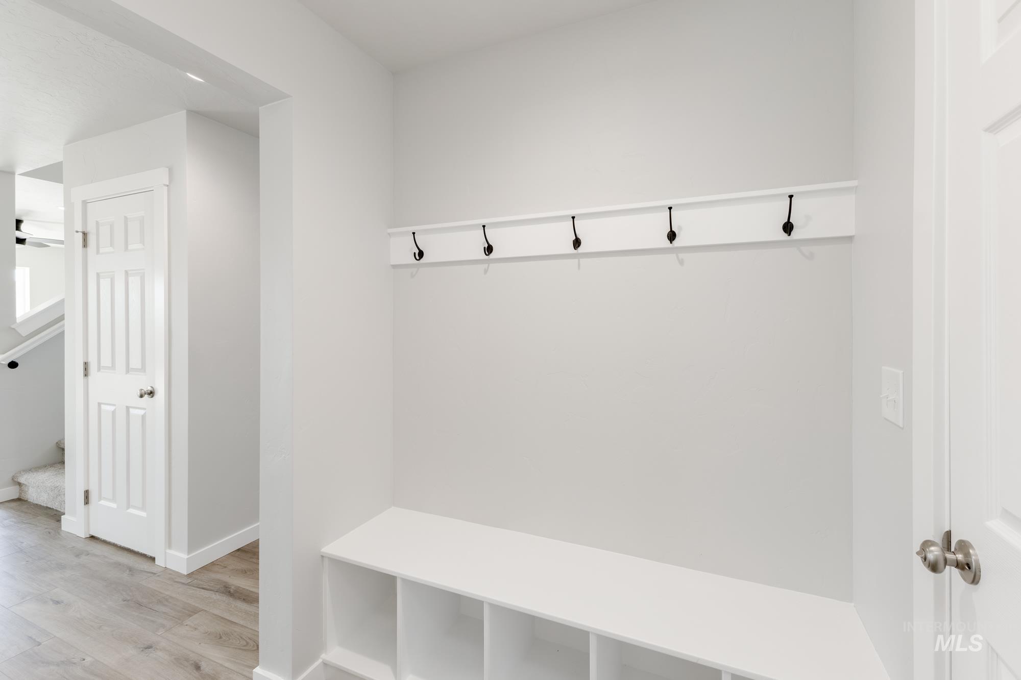 Mudroom with wood finished floors and a ceiling fan
