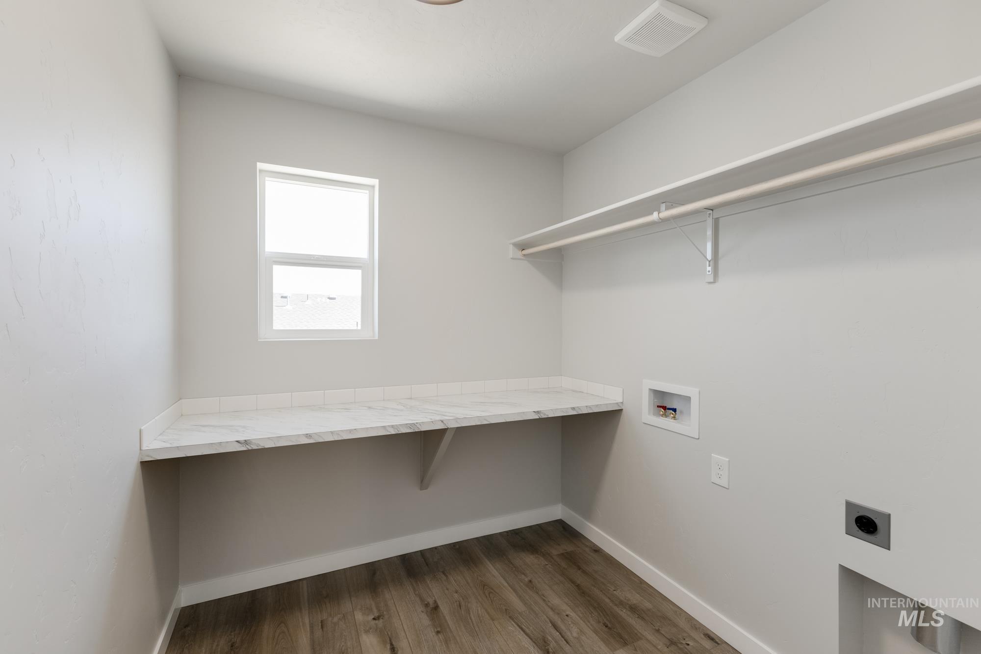 Washroom featuring washer hookup, dark wood-style flooring, and electric dryer hookup
