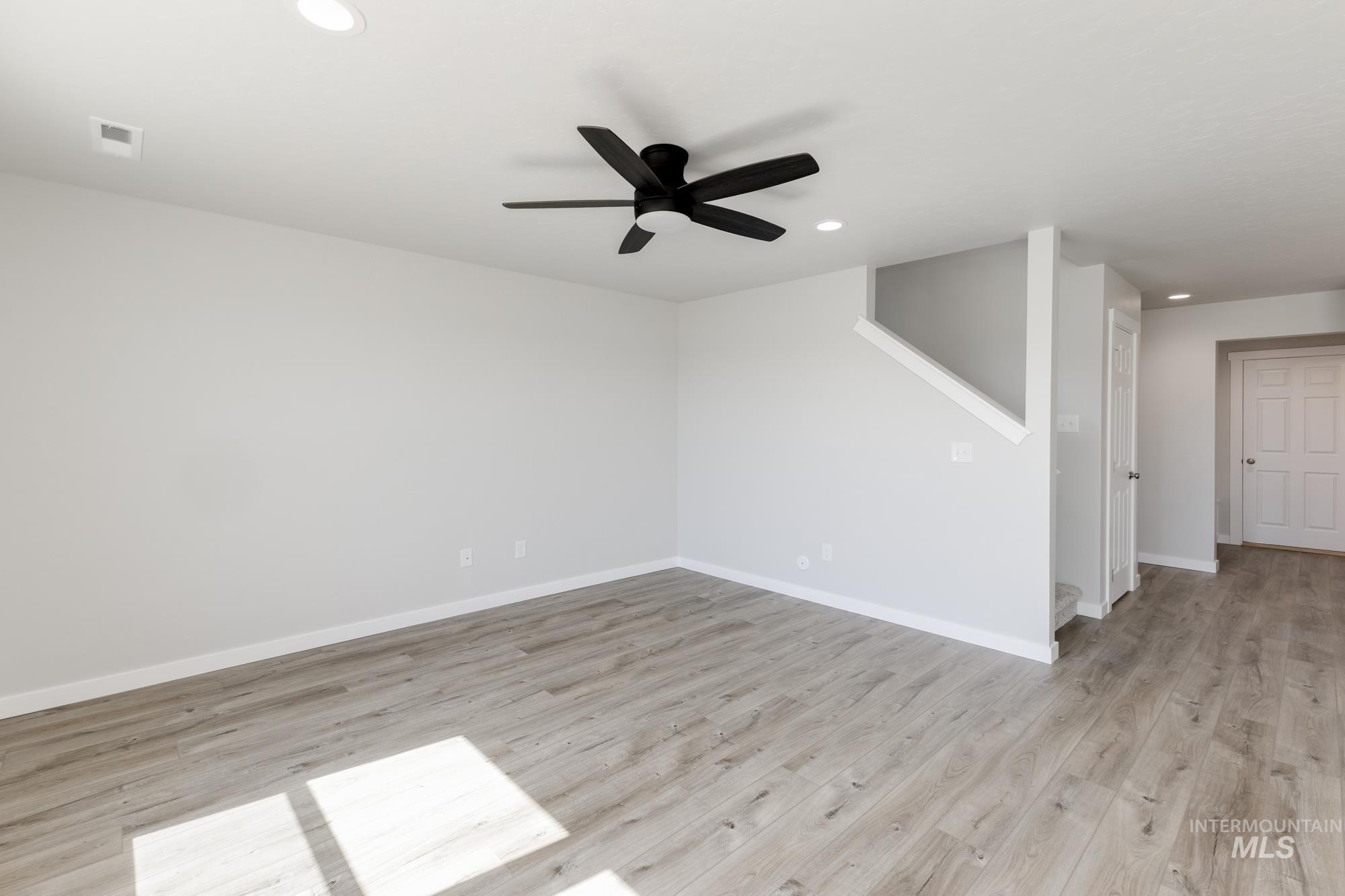 Empty room featuring light wood finished floors, recessed lighting, and ceiling fan
