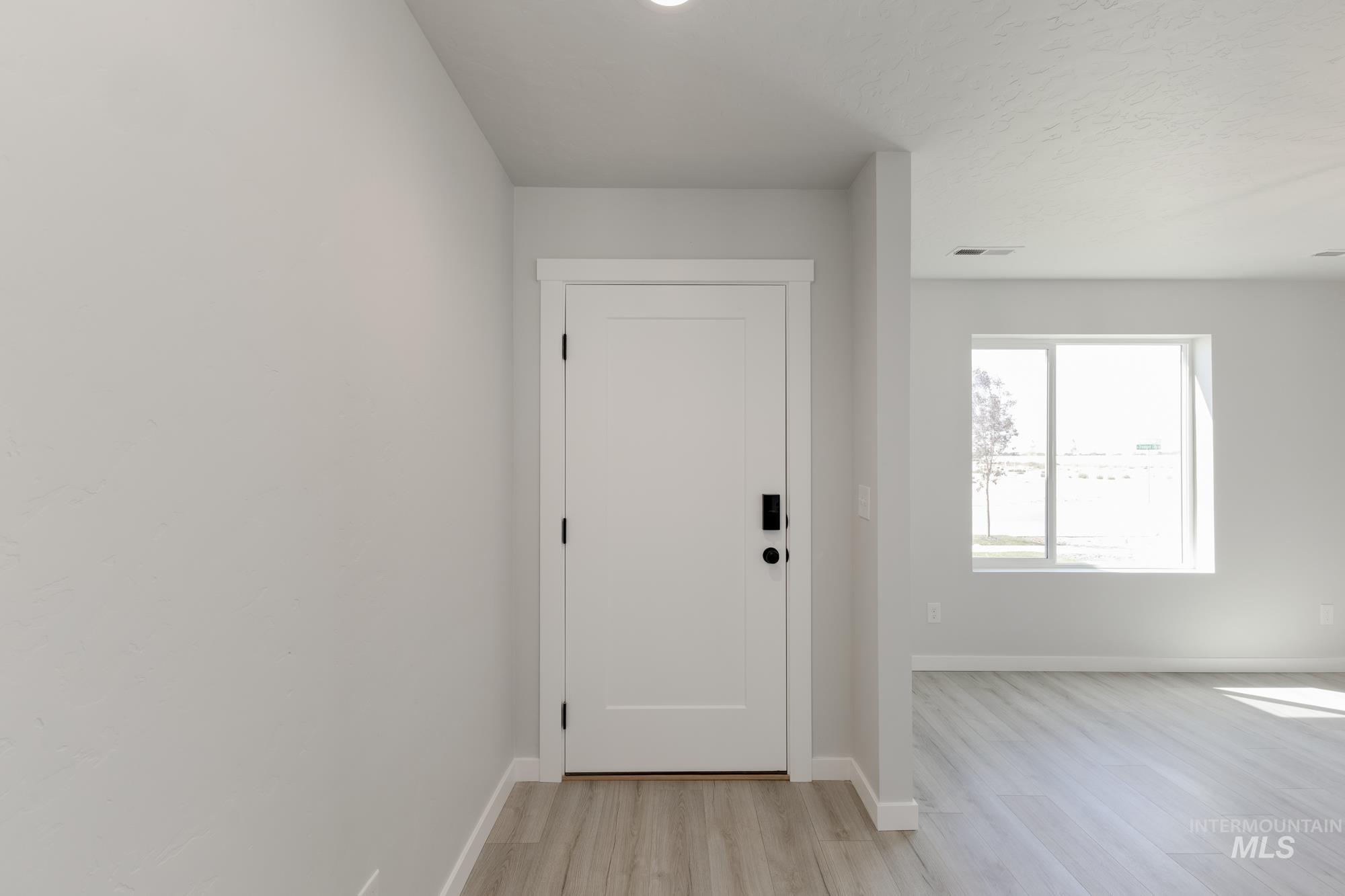 Entryway featuring baseboards and light wood-style floors