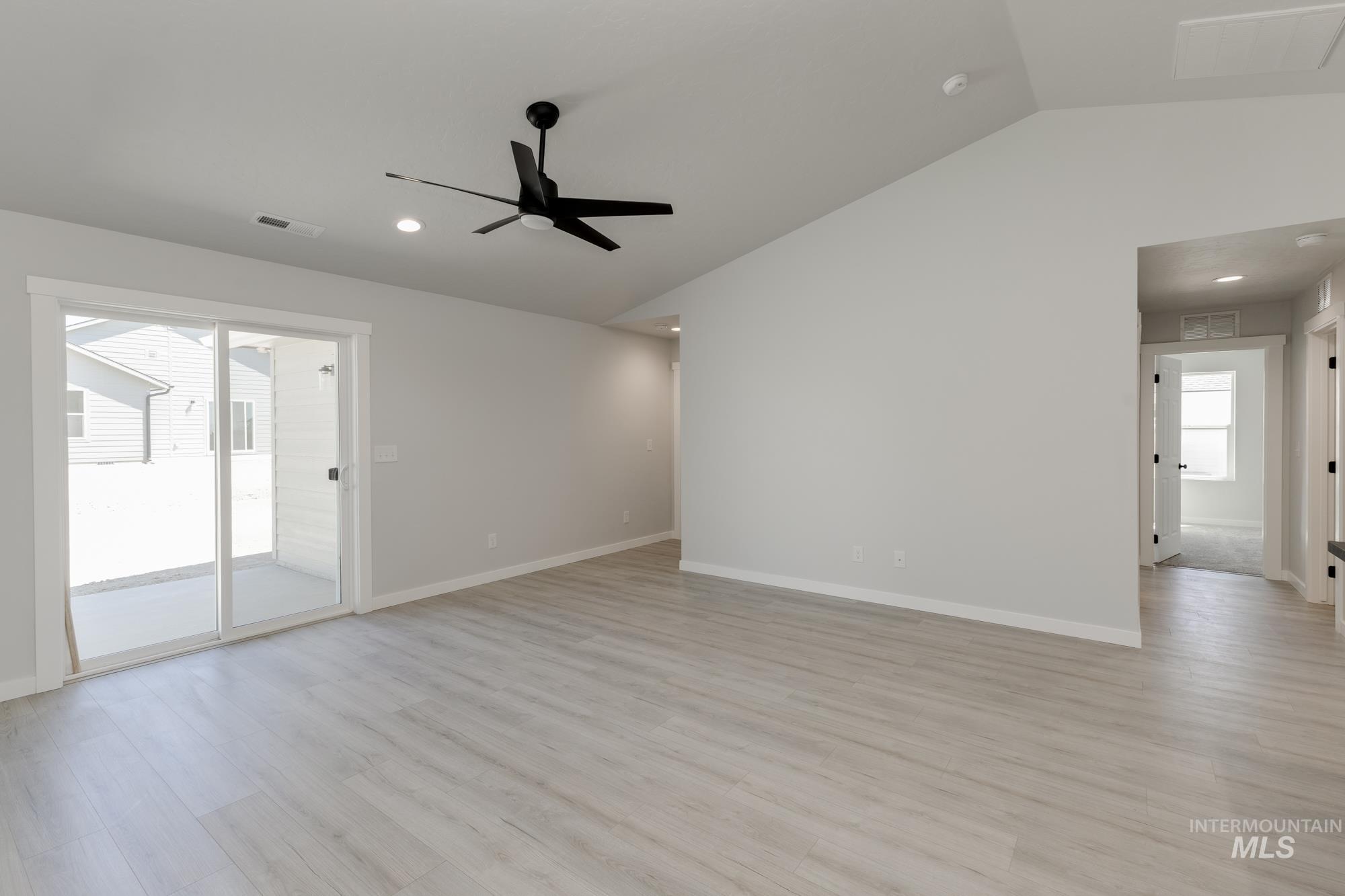 Unfurnished room featuring vaulted ceiling, light wood-style floors, recessed lighting, and a ceiling fan