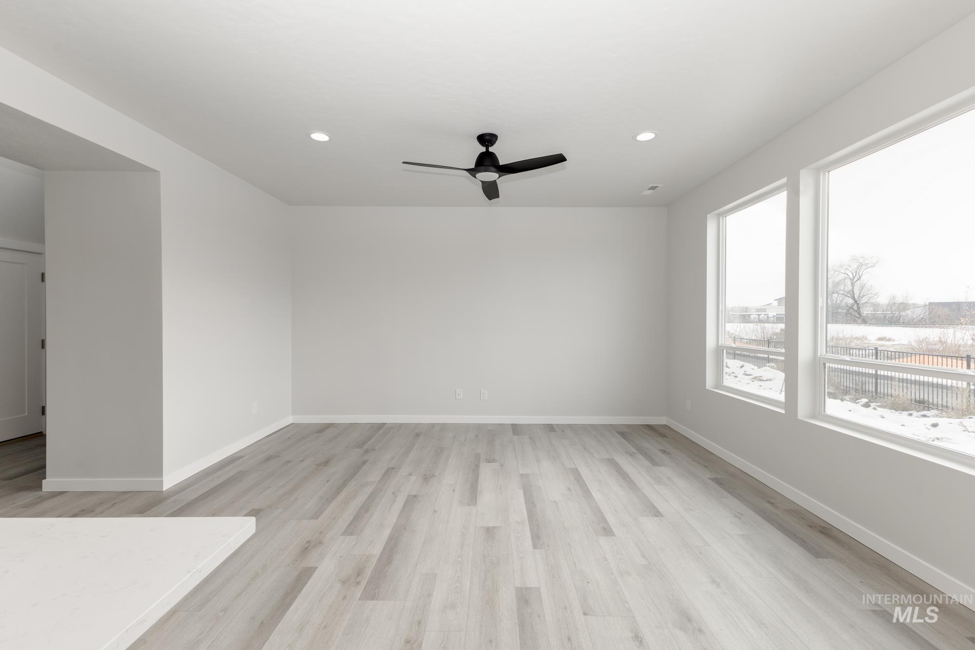 Empty room with light wood finished floors, recessed lighting, and ceiling fan