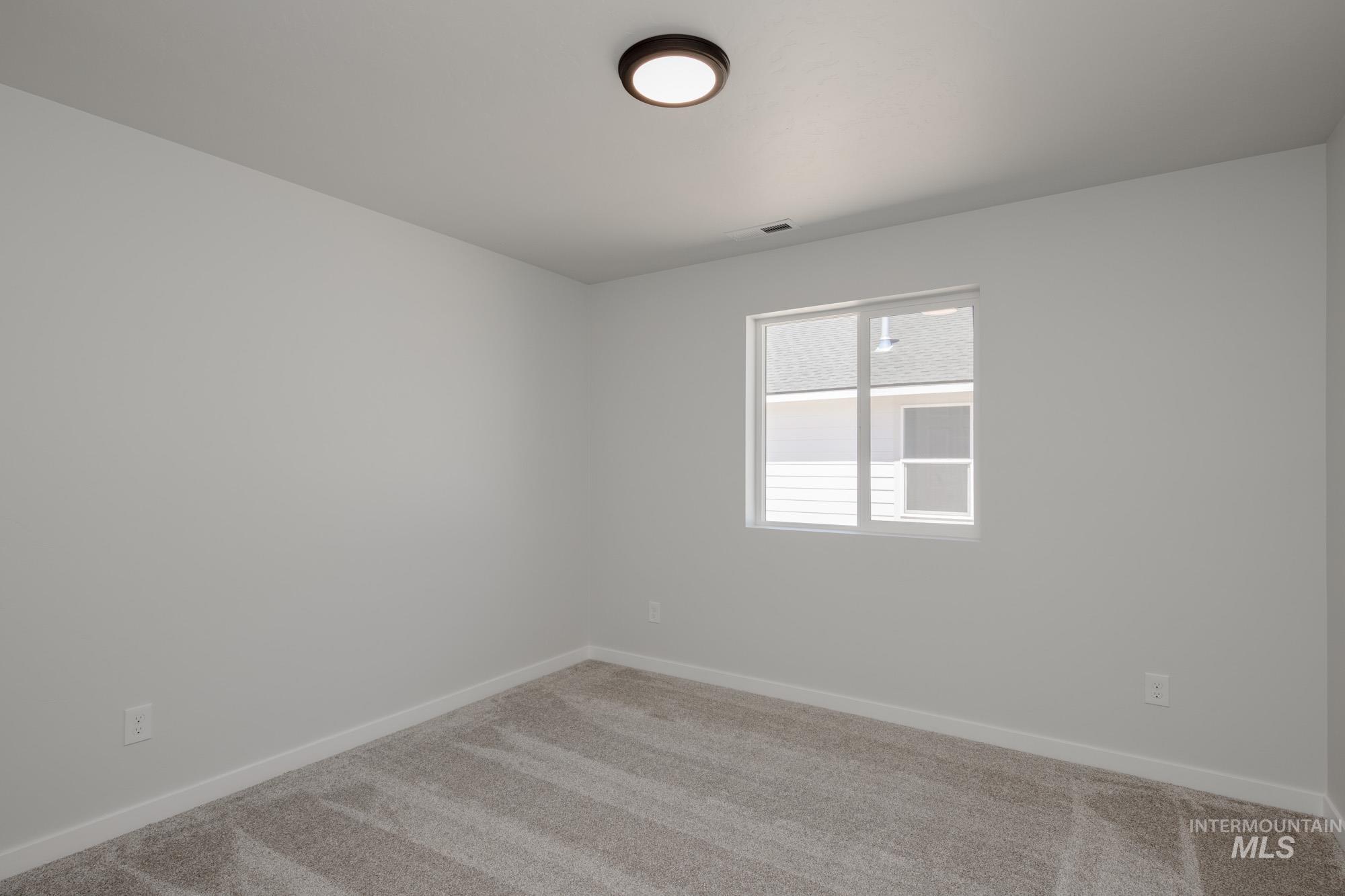 Unfurnished room featuring carpet flooring and baseboards