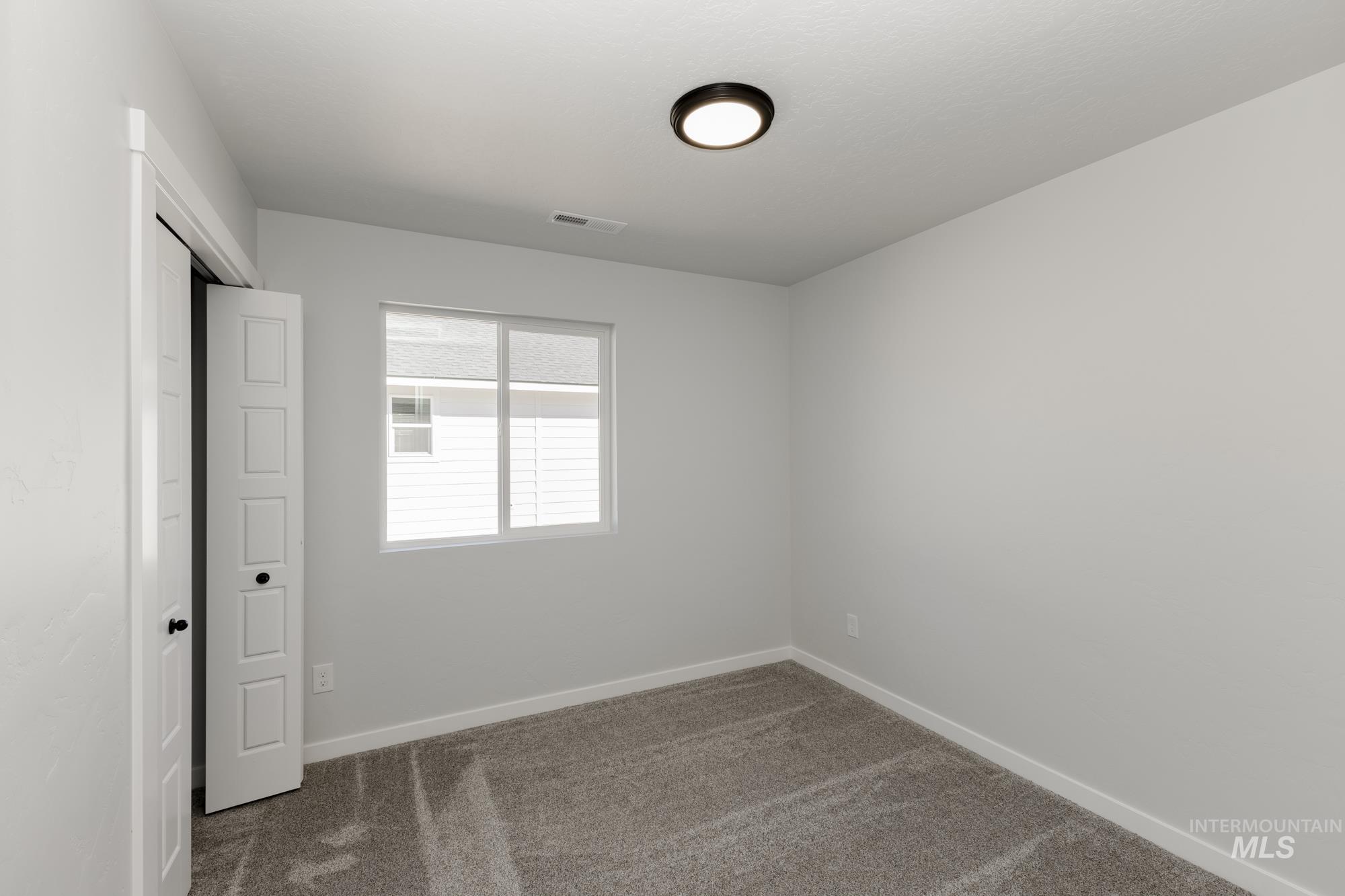 Unfurnished bedroom featuring carpet flooring and a closet