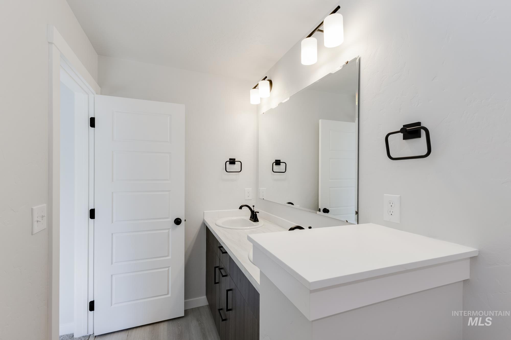 Bathroom with vanity and light wood-style floors