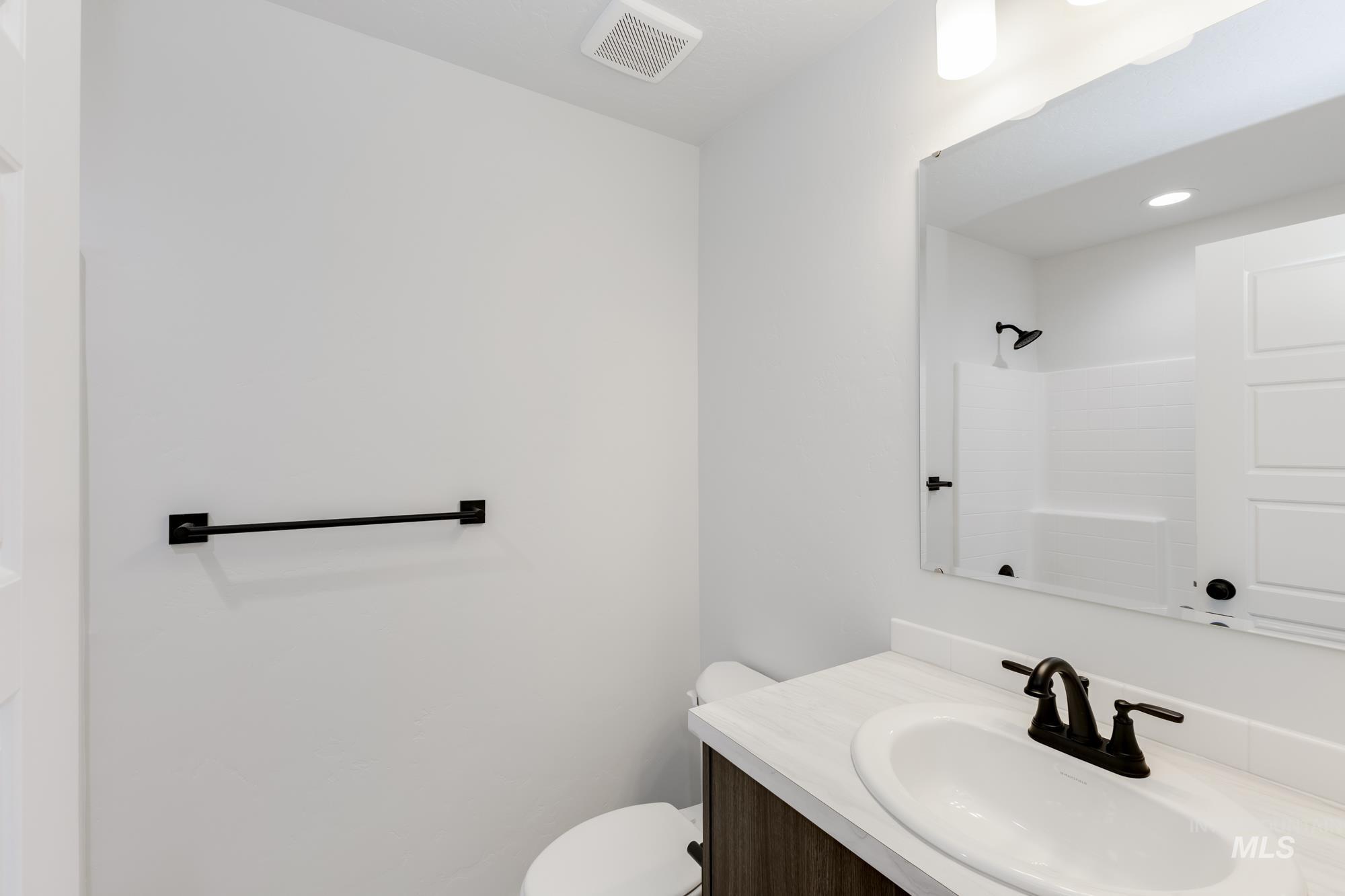 Bathroom featuring vanity and a shower