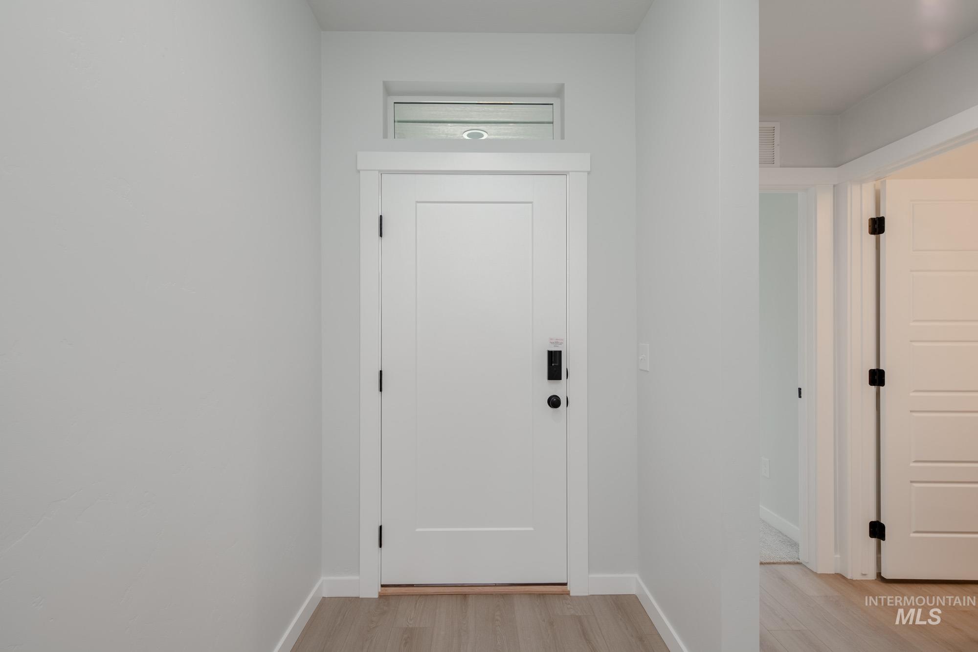 Entryway with baseboards and wood finished floors