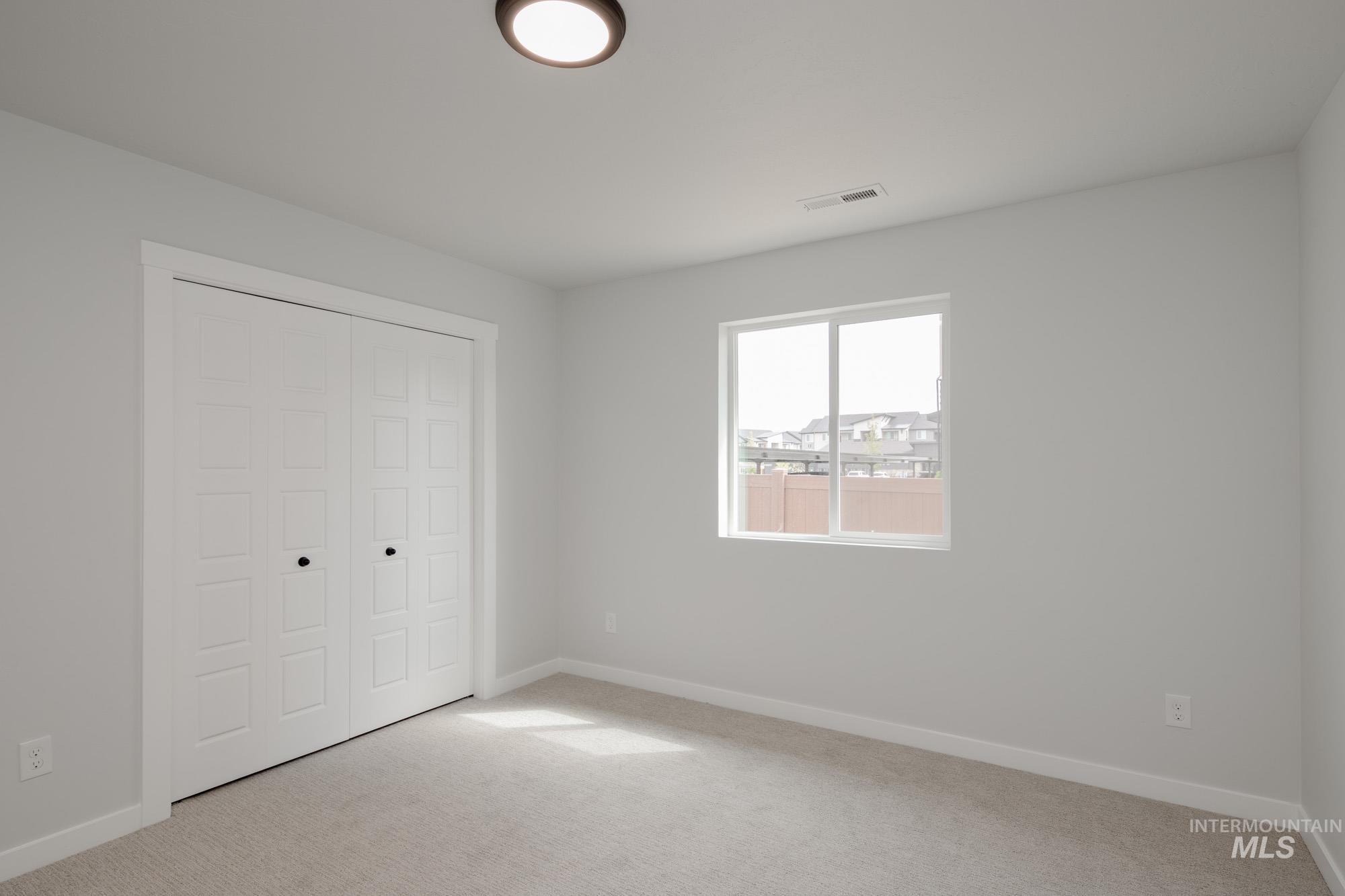 Unfurnished bedroom featuring carpet flooring and a closet