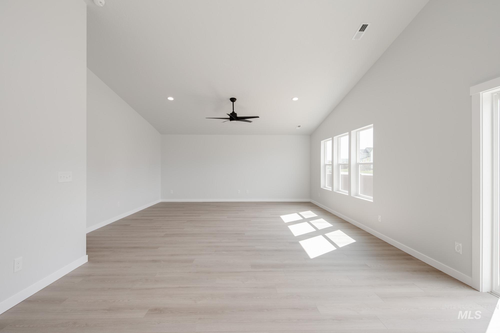 Bonus room with lofted ceiling, light wood-style floors, recessed lighting, and ceiling fan