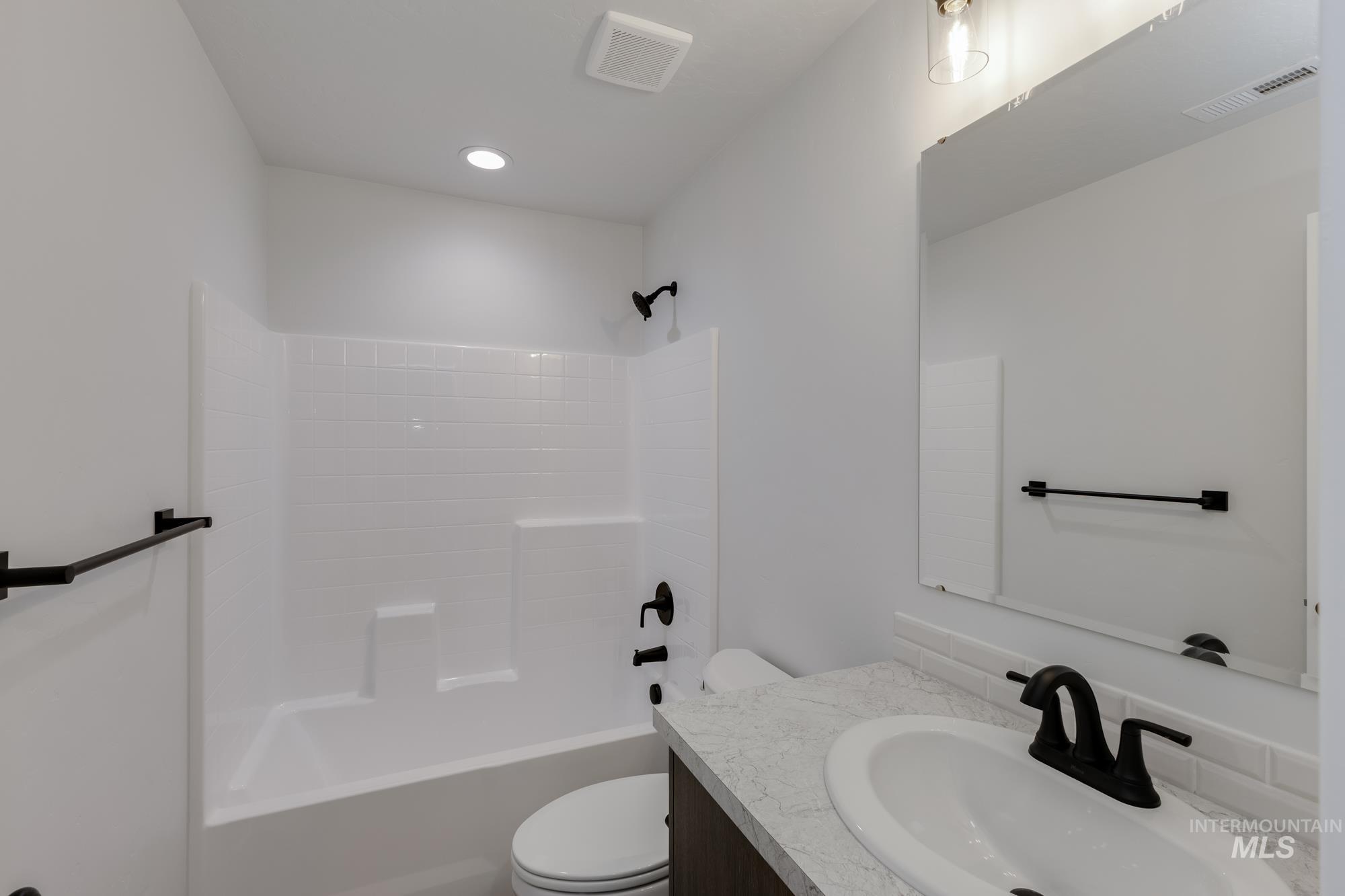 Bathroom featuring vanity and shower / bath combination