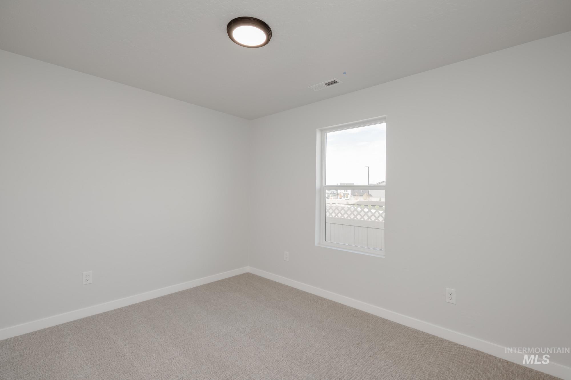 Unfurnished room featuring carpet floors and baseboards