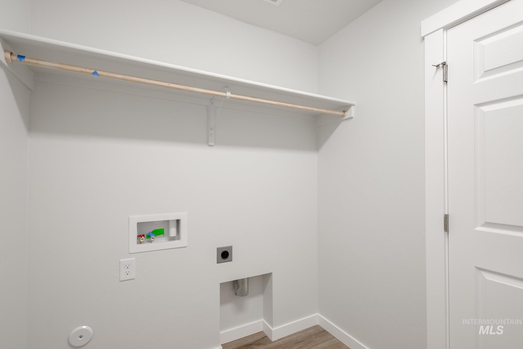 Laundry room featuring light wood finished floors, electric dryer hookup, and hookup for a washing machine