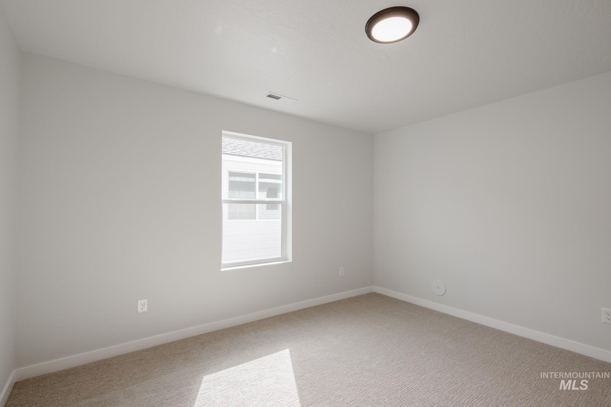 Empty room with baseboards and carpet floors
