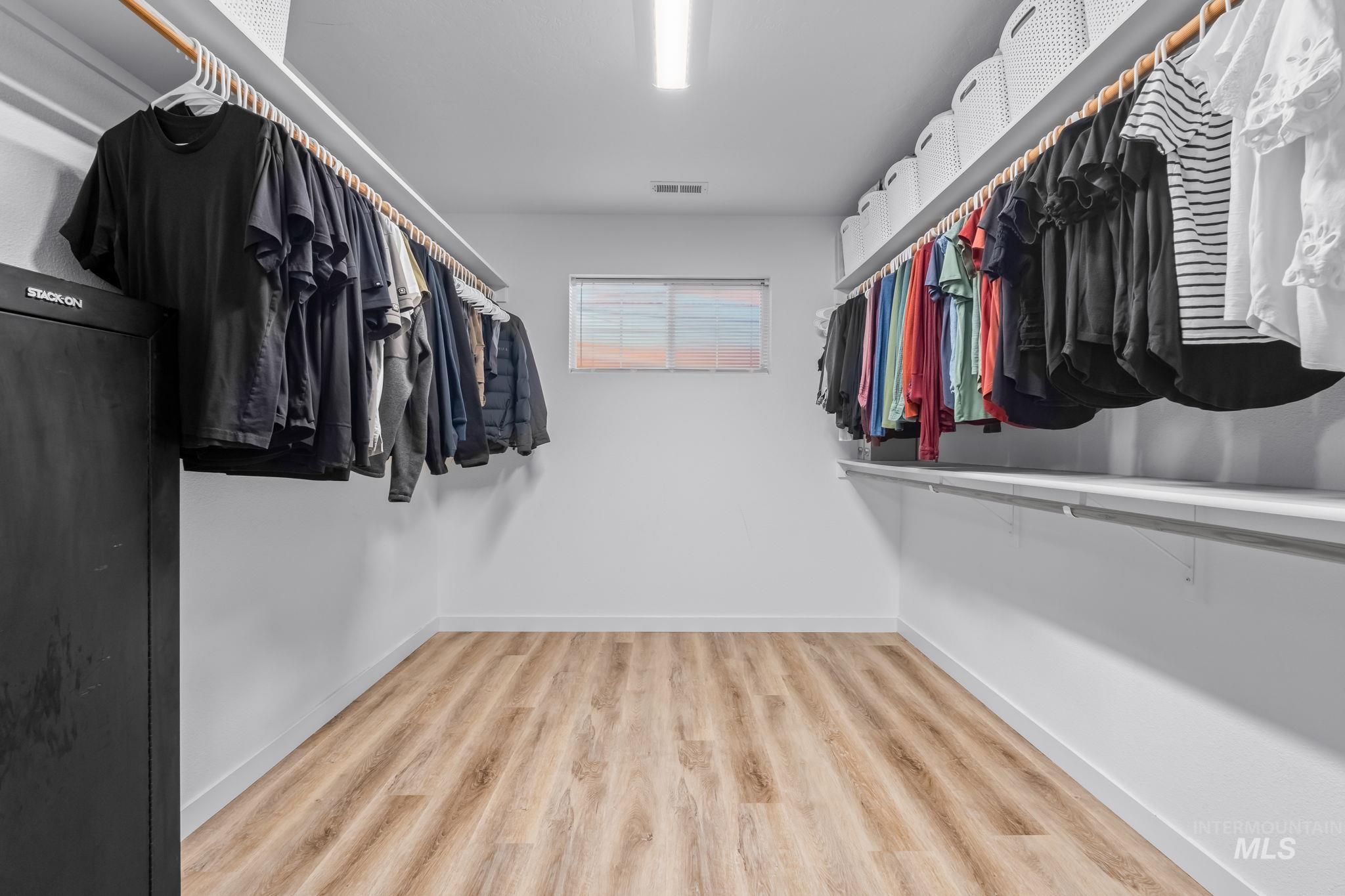 Walk in closet featuring light wood-style floors