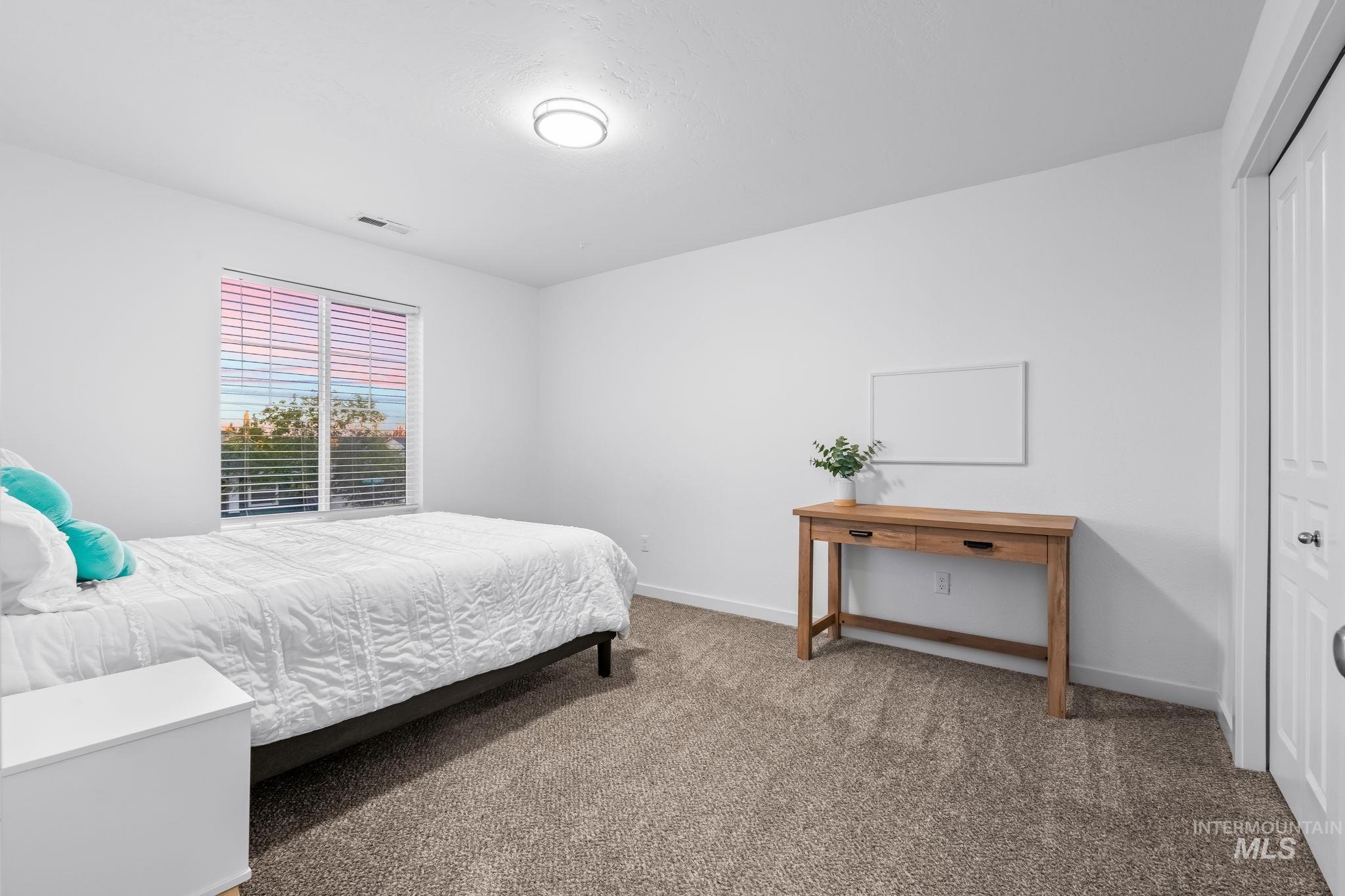 Bedroom with carpet and a closet