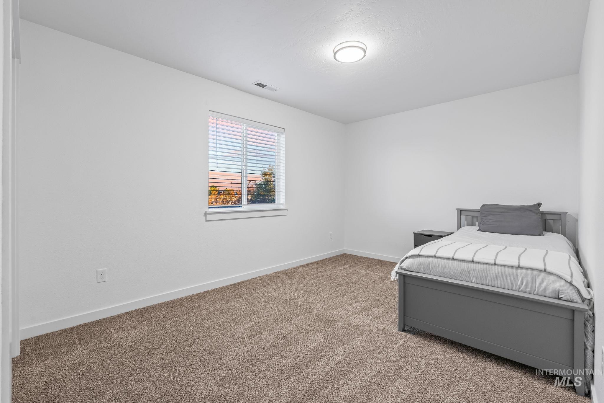 Bedroom with carpet floors and baseboards