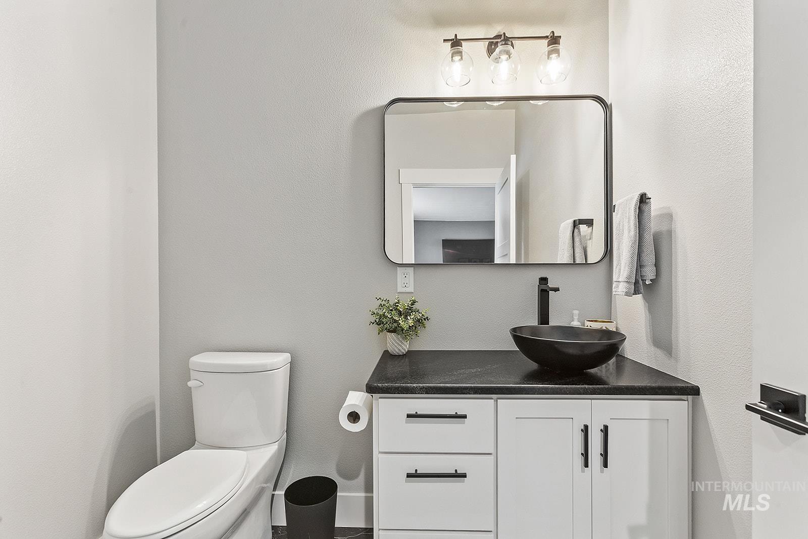 Half bath with vanity and toilet