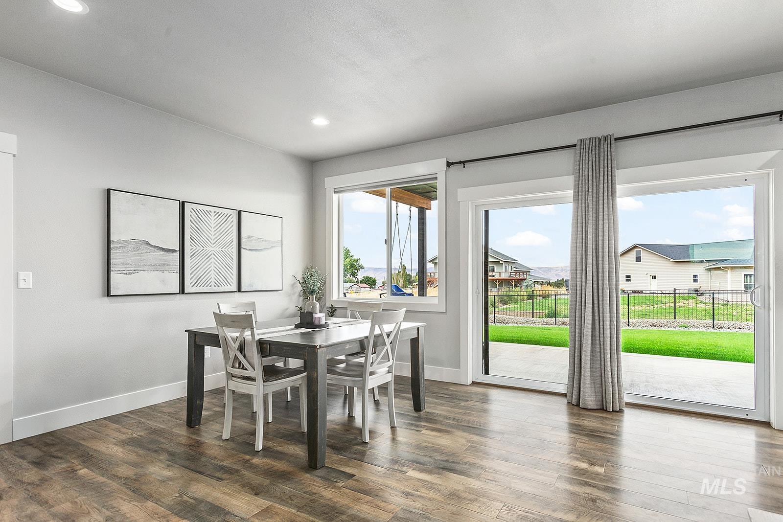 Dining area featuring dark wood finished floors and recessed lighting