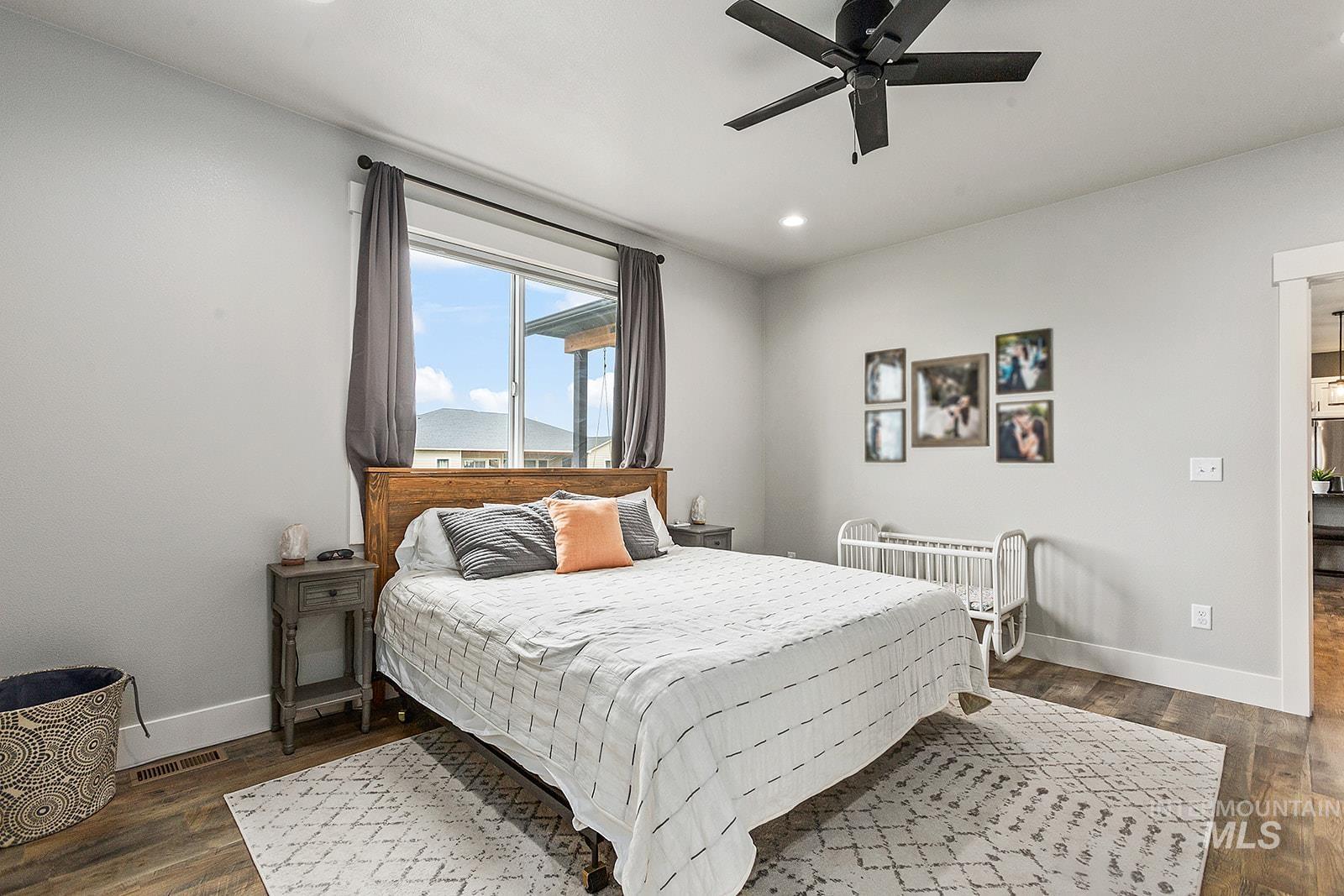 Bedroom with dark wood finished floors, ceiling fan, and recessed lighting