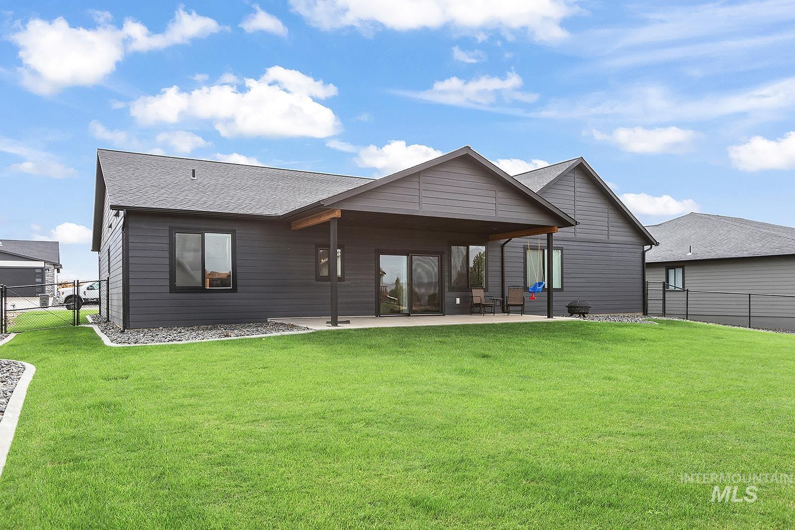 Rear view of property with a patio and a shingled roof