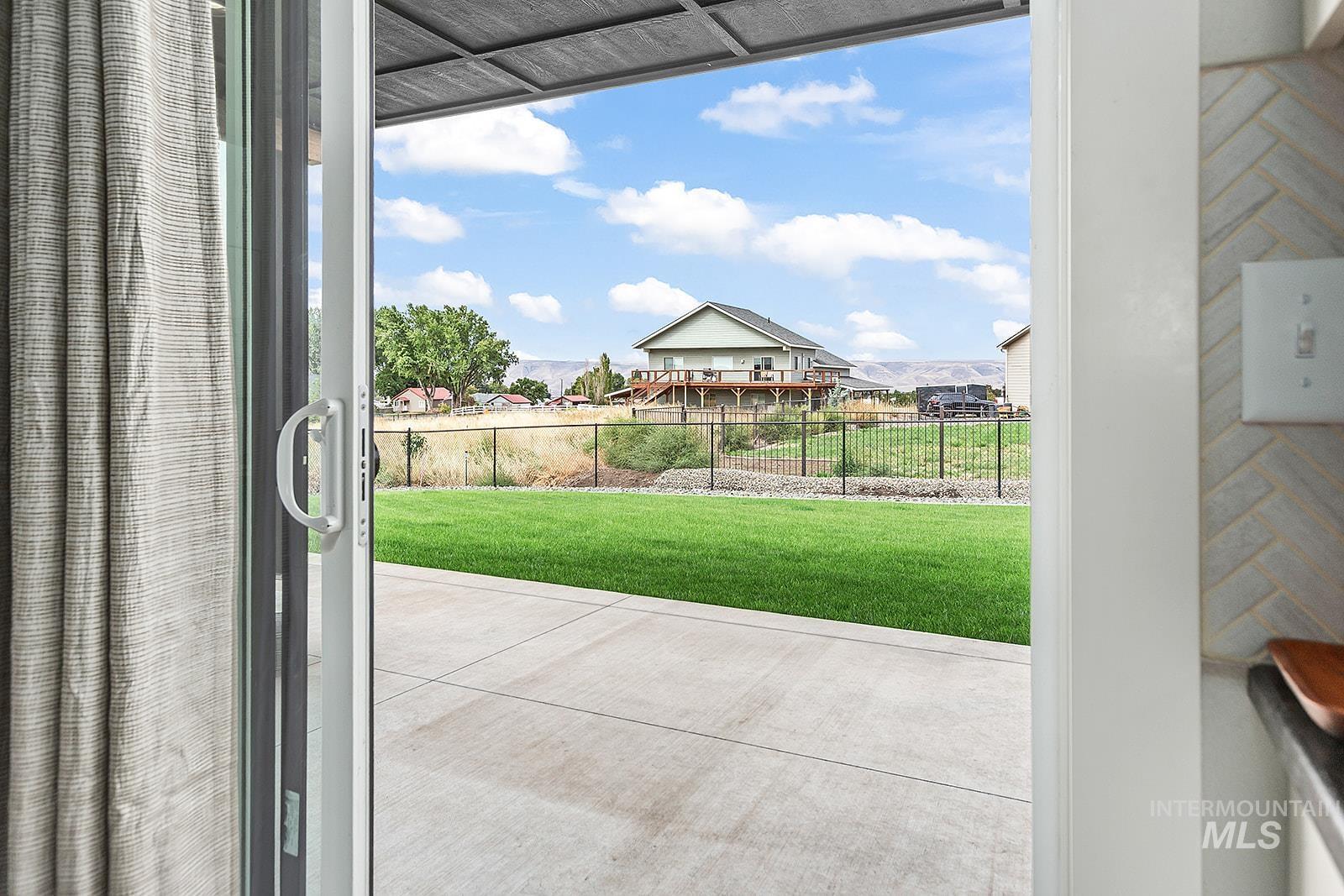 Doorway to outside featuring a residential view and healthy amount of natural light