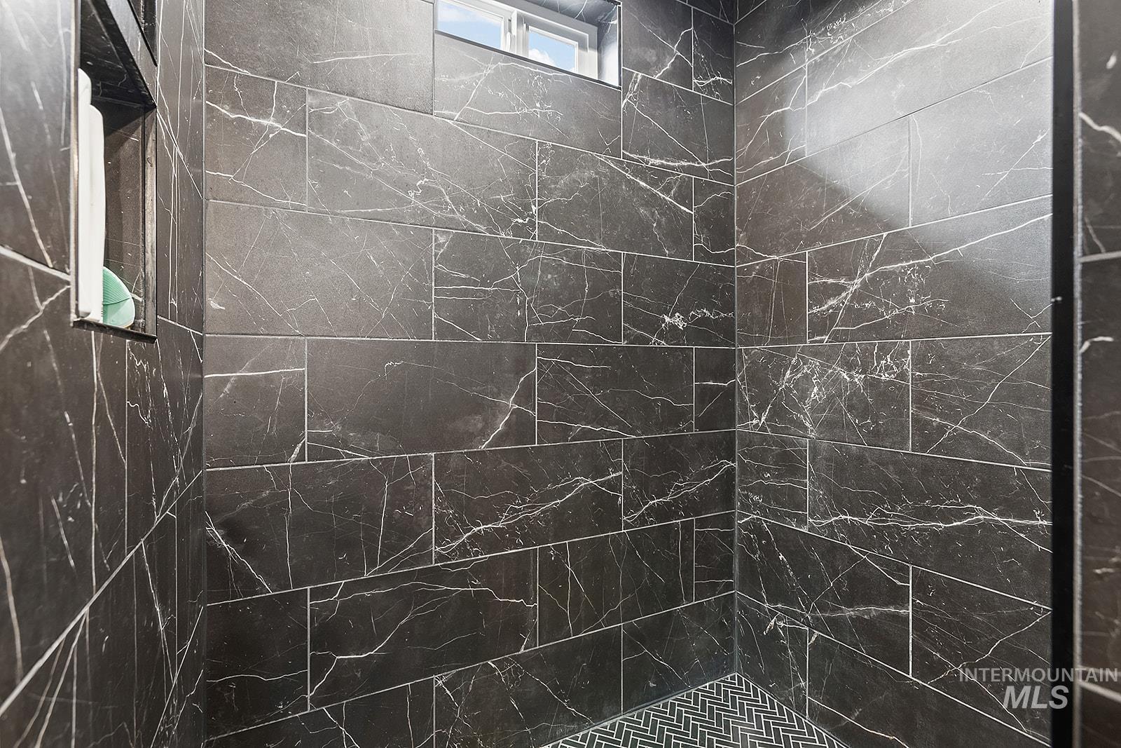 Bathroom with a marble finish shower