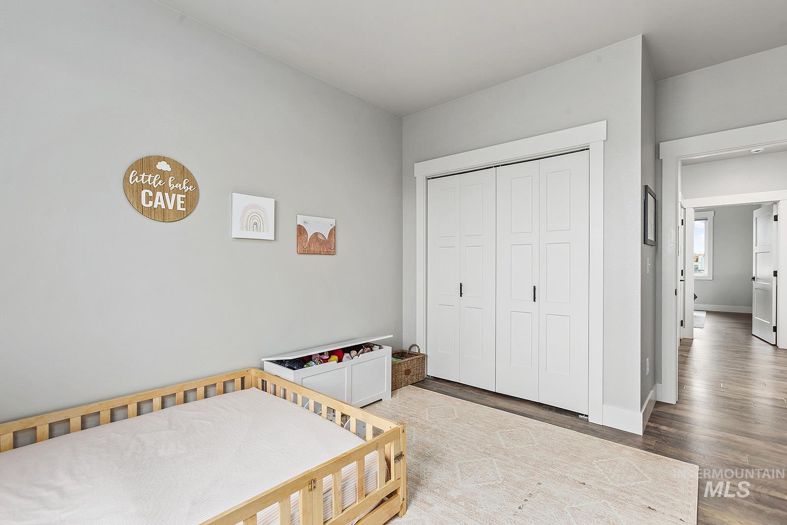 Bedroom with a closet and wood finished floors